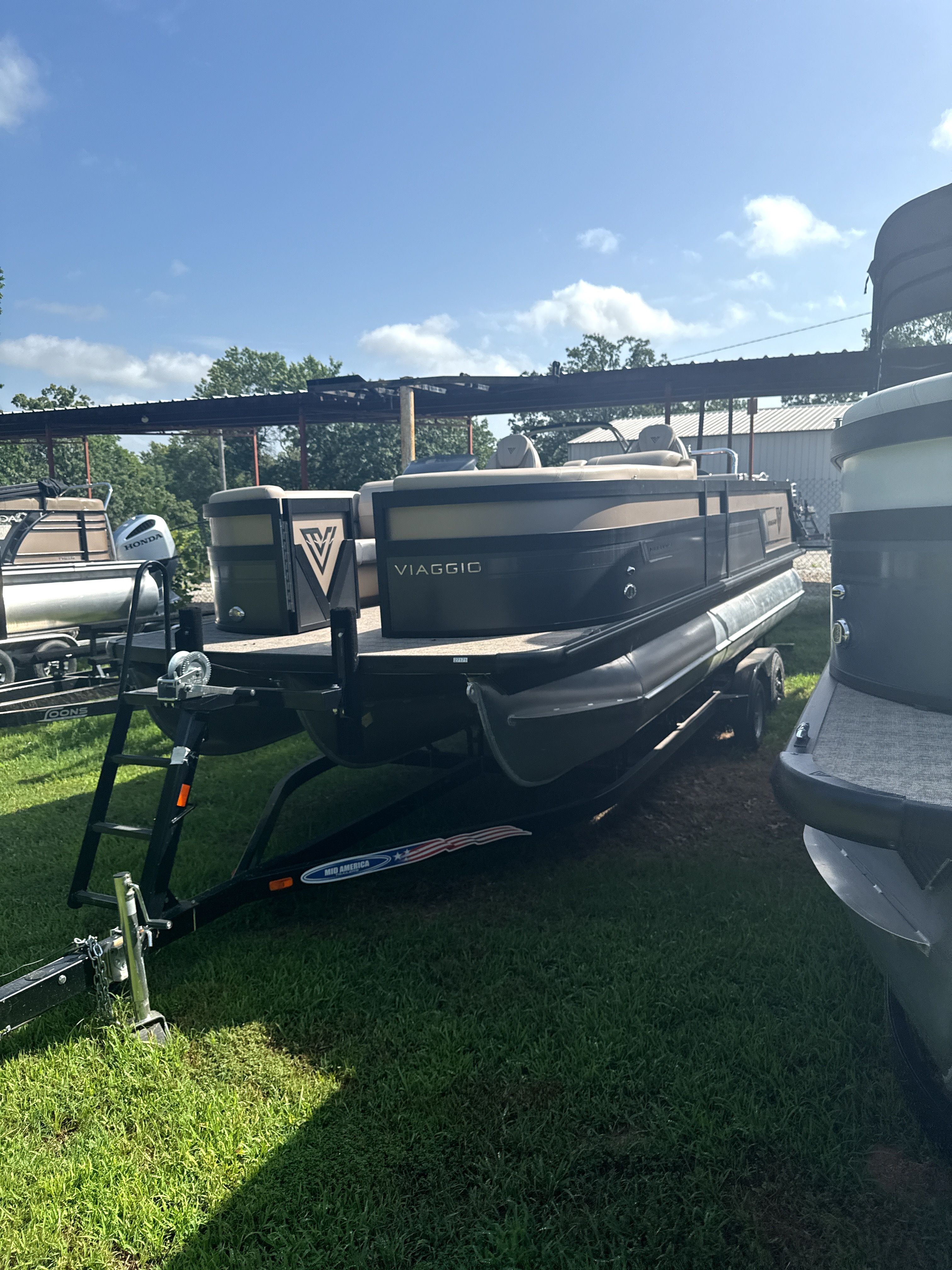 Viaggio Diamante D23S 2023 pontoon boat on trailer outdoors.