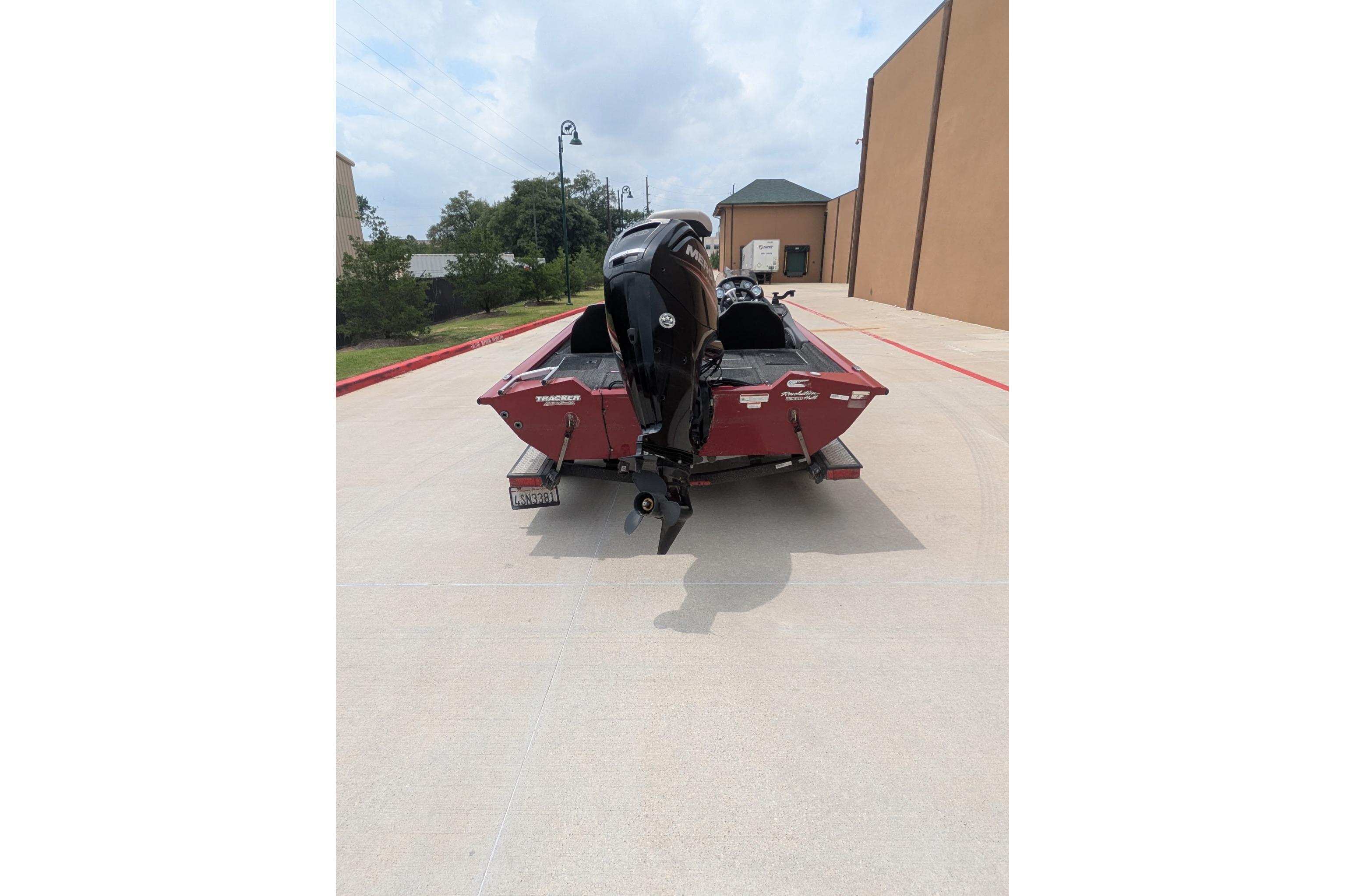 2019 Tracker Pro Team 190 boat with outboard motor on a concrete driveway.