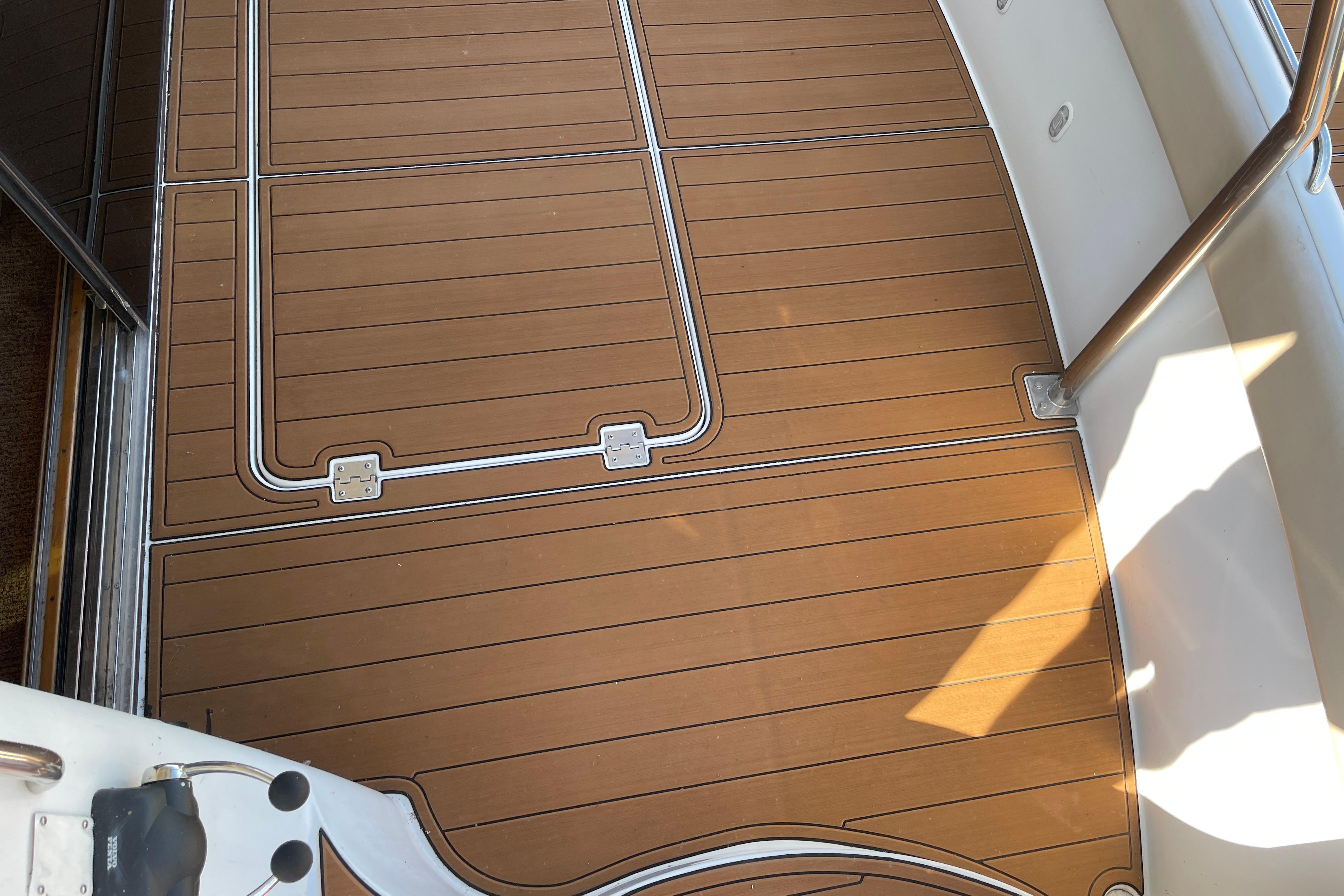 Teak deck of 2002 Carver 570 Voyager Pilothouse yacht, featuring sleek design and stainless steel accents.