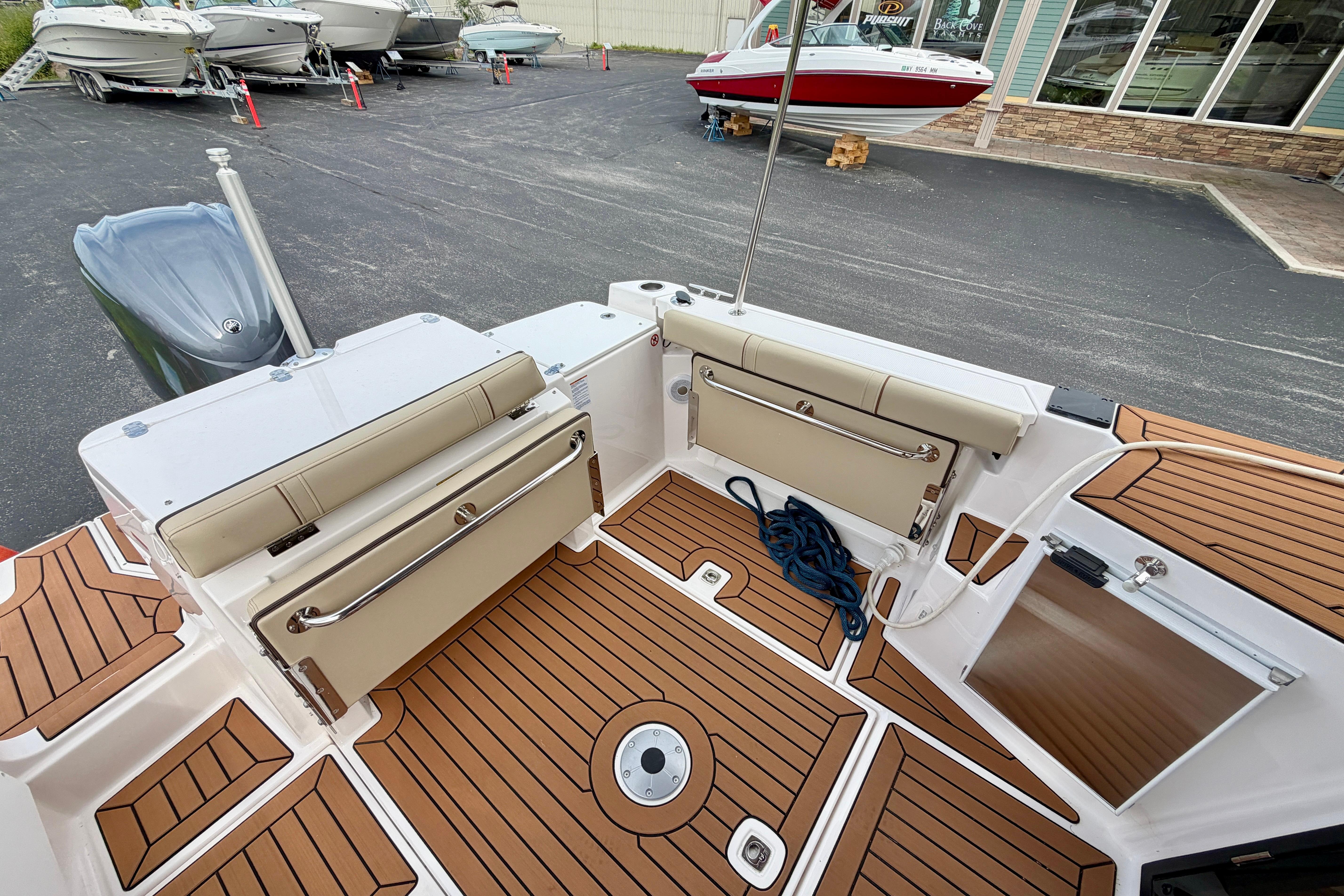 2025 Ranger Tugs R-27 boat interior with teak flooring and seating.