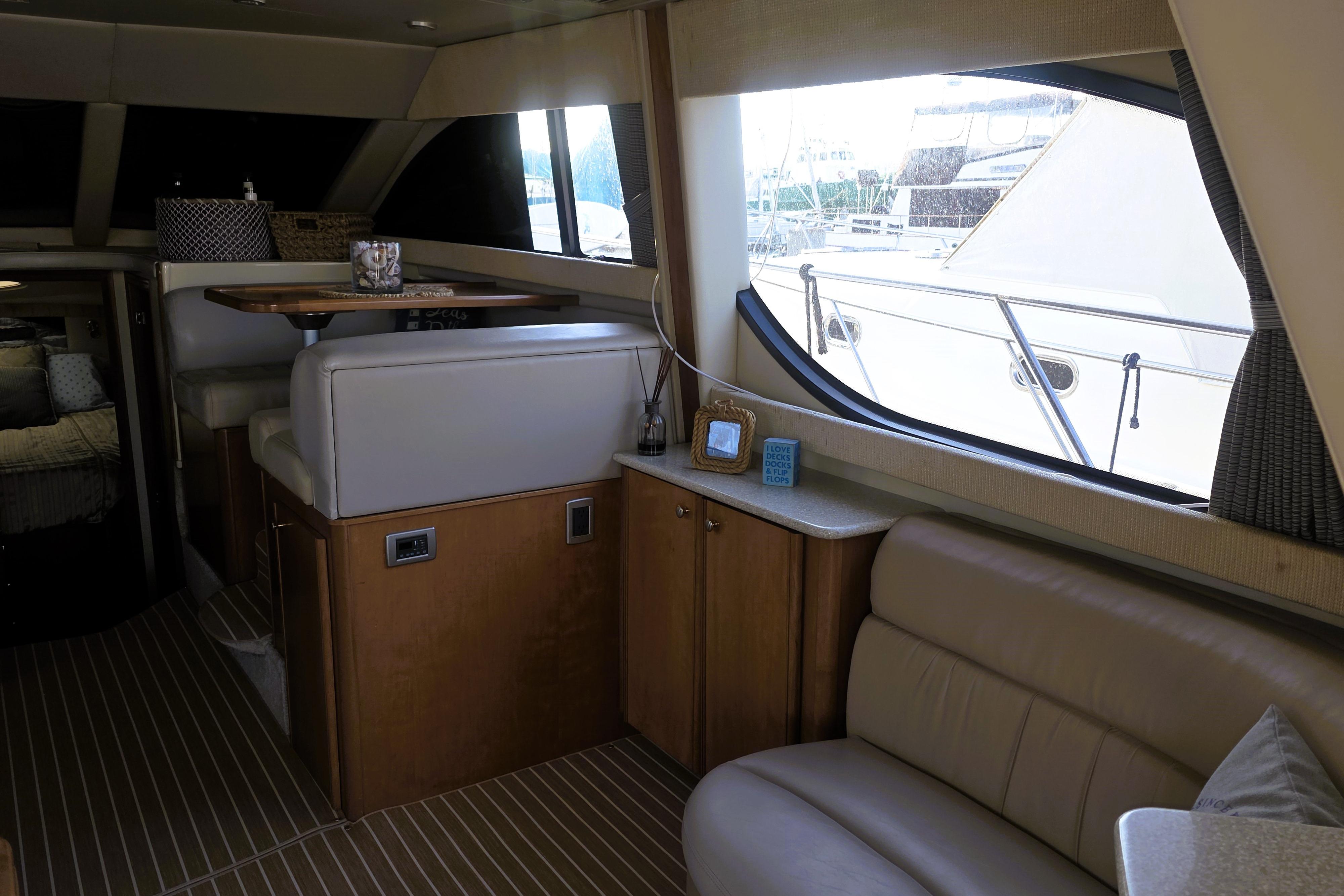2004 Meridian 391 Sedan interior with seating, table, and large window view.
