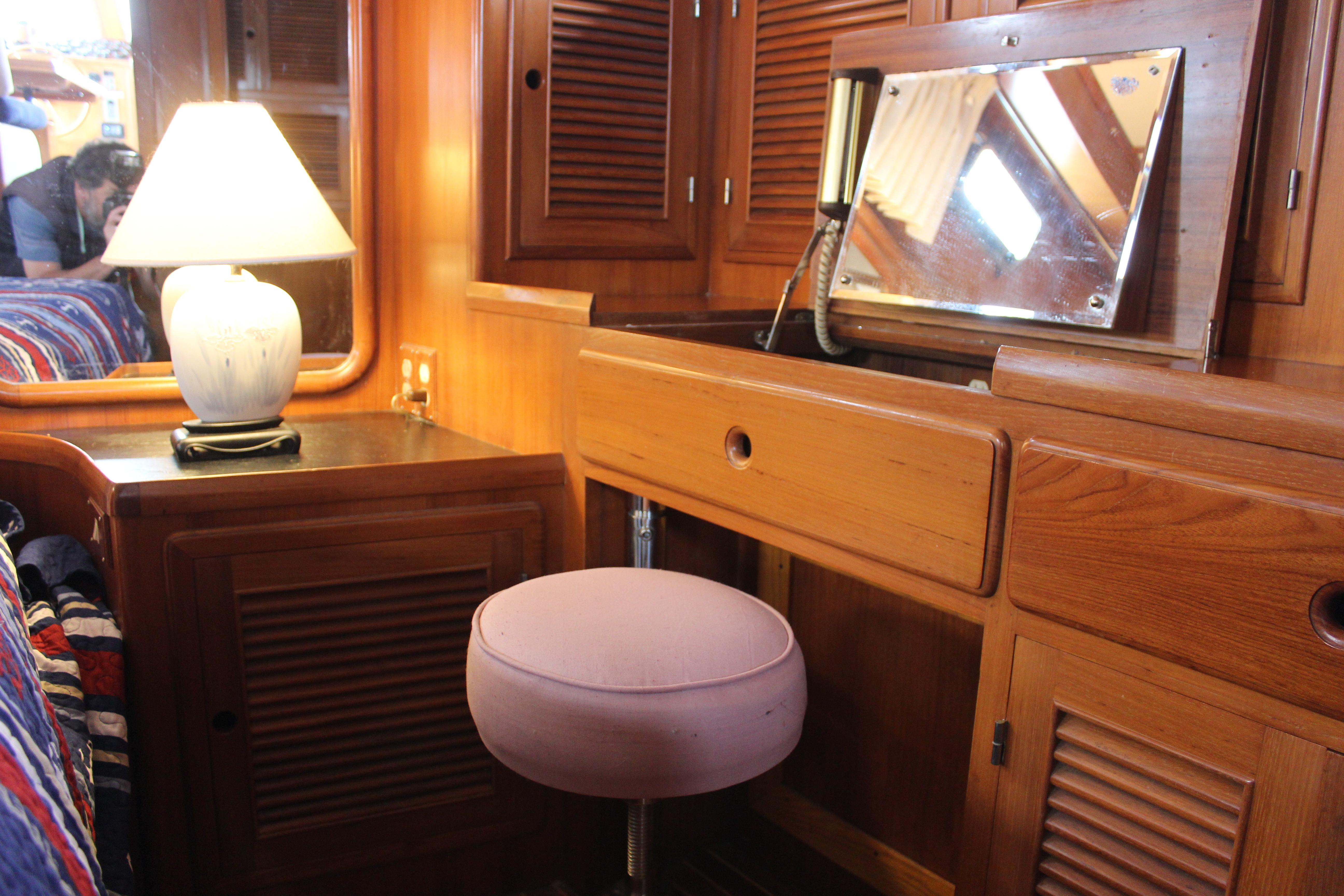 Interior of 1986 Kha Shing Spindrift 46 yacht with wooden cabinetry and vanity area.