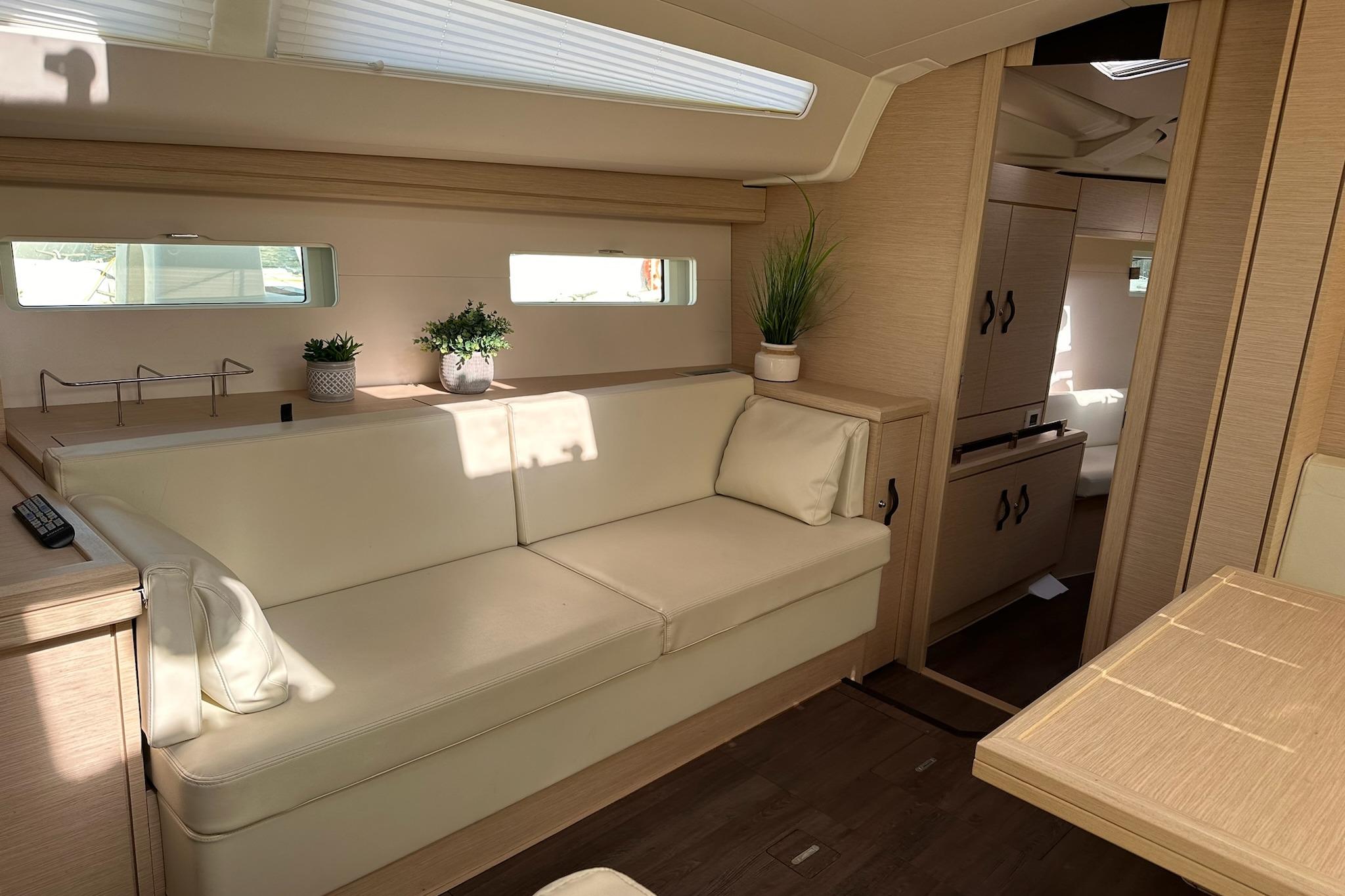 Interior of 2018 Jeanneau 51 yacht with beige seating and modern decor.