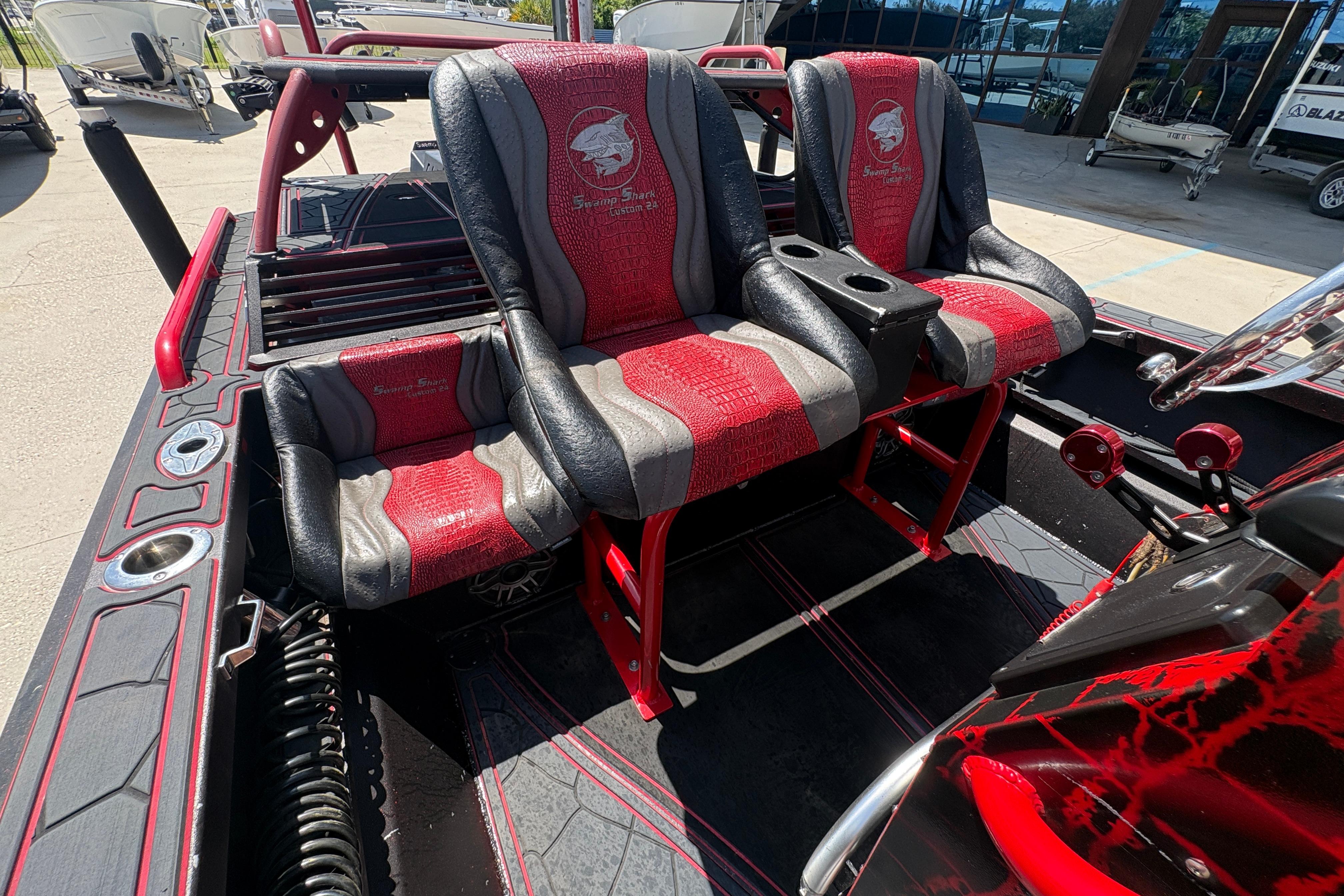 Custom 2018 Swamp Shark 24' boat interior with red and black seating and console.
