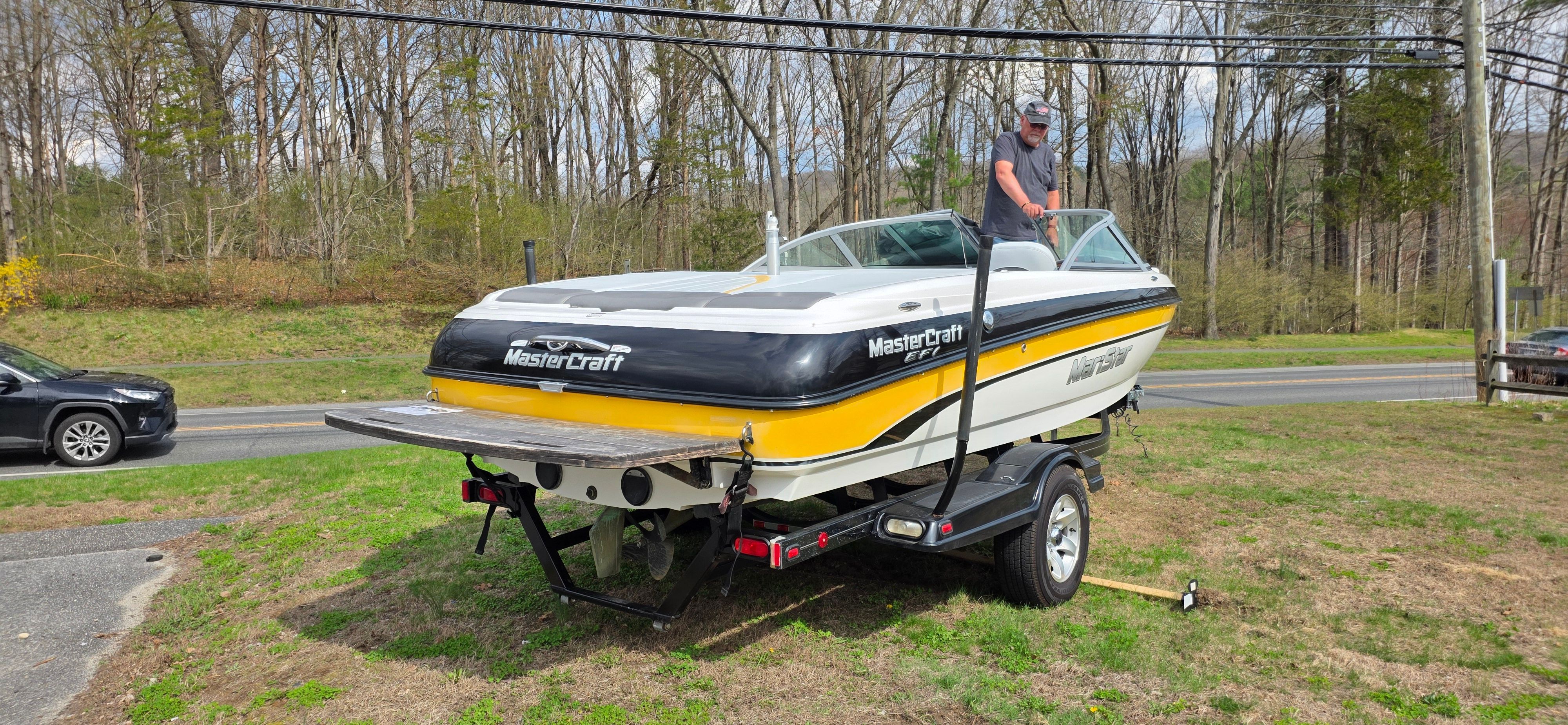 2004 MasterCraft Maristar boat parked on trailer outdoors.