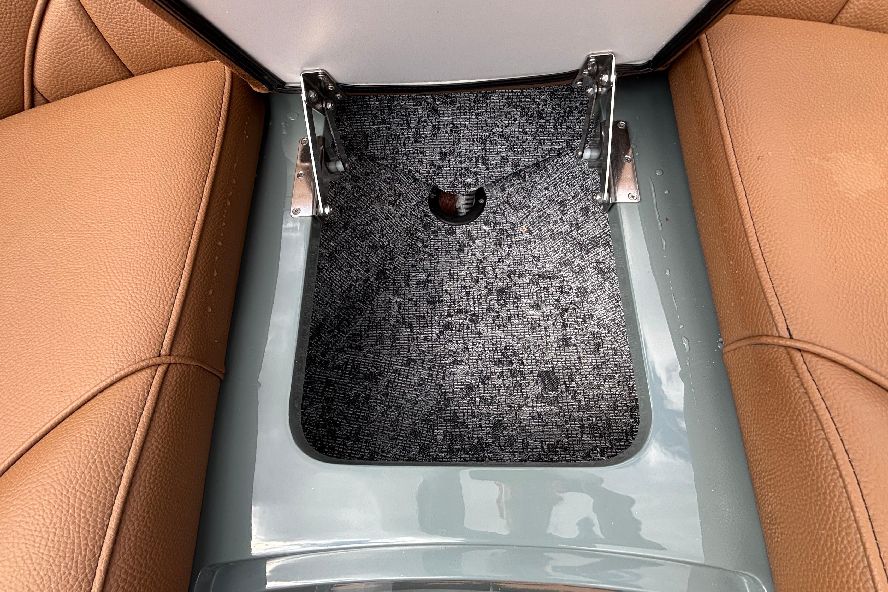 2026 MB B52 23 Classic interior storage compartment with brown leather seats and gray carpet.