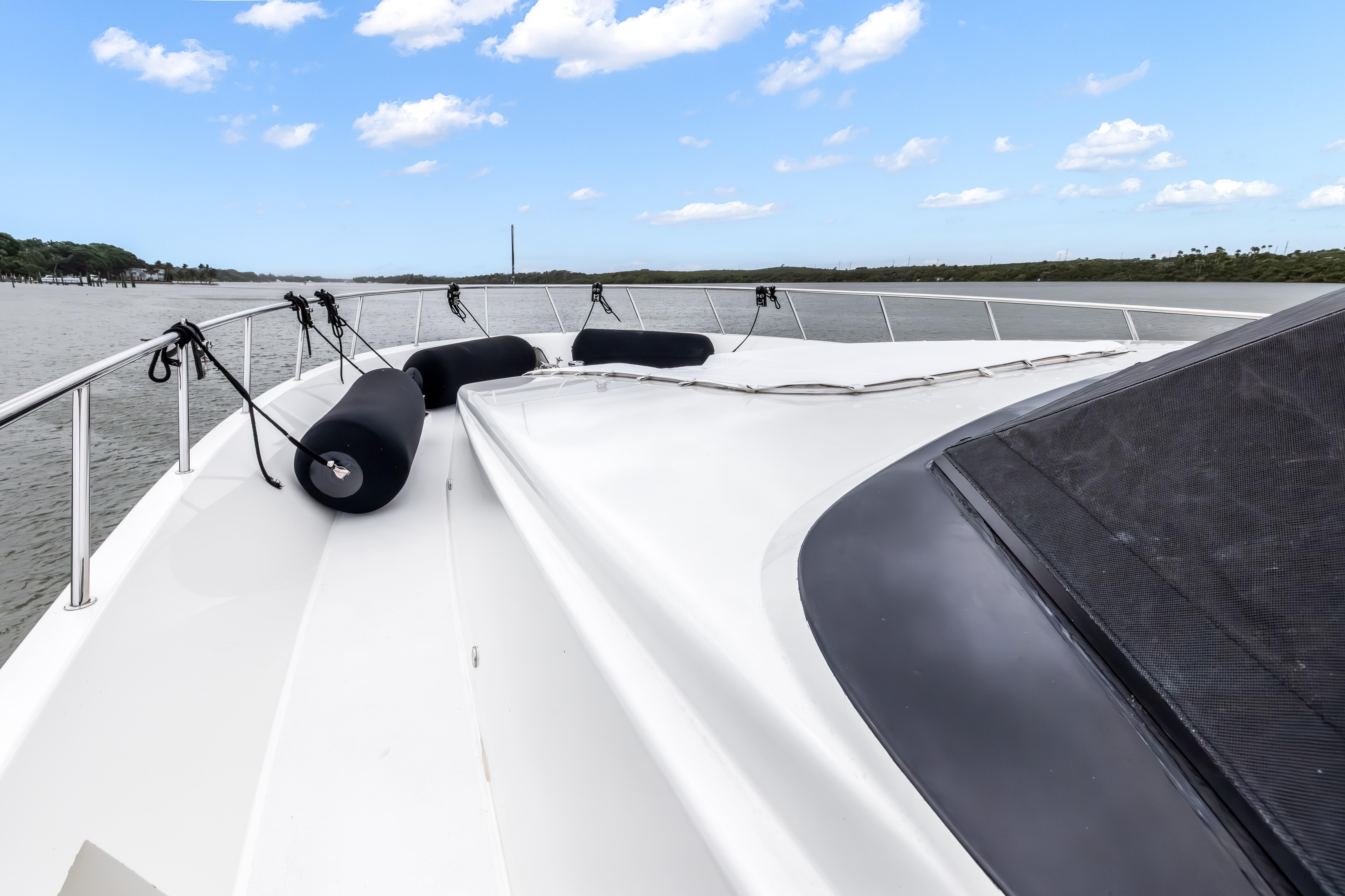 Bow view of 2012 Cheoy Lee 84 Bravo yacht on a calm waterway.