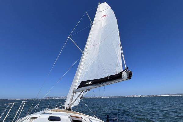 2025 Hanse 360 sailboat on open water under clear blue sky.