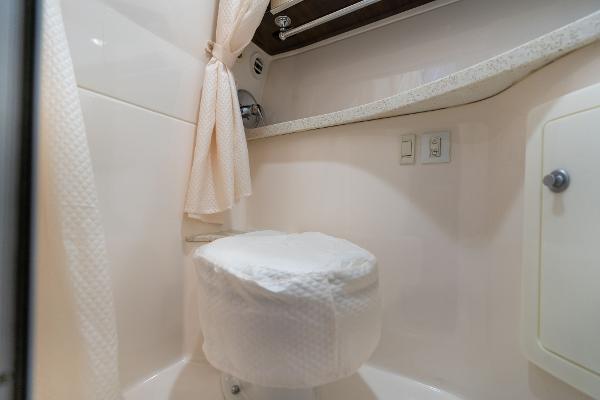 2016 Regal 28 Express boat bathroom interior with toilet and shower curtain.