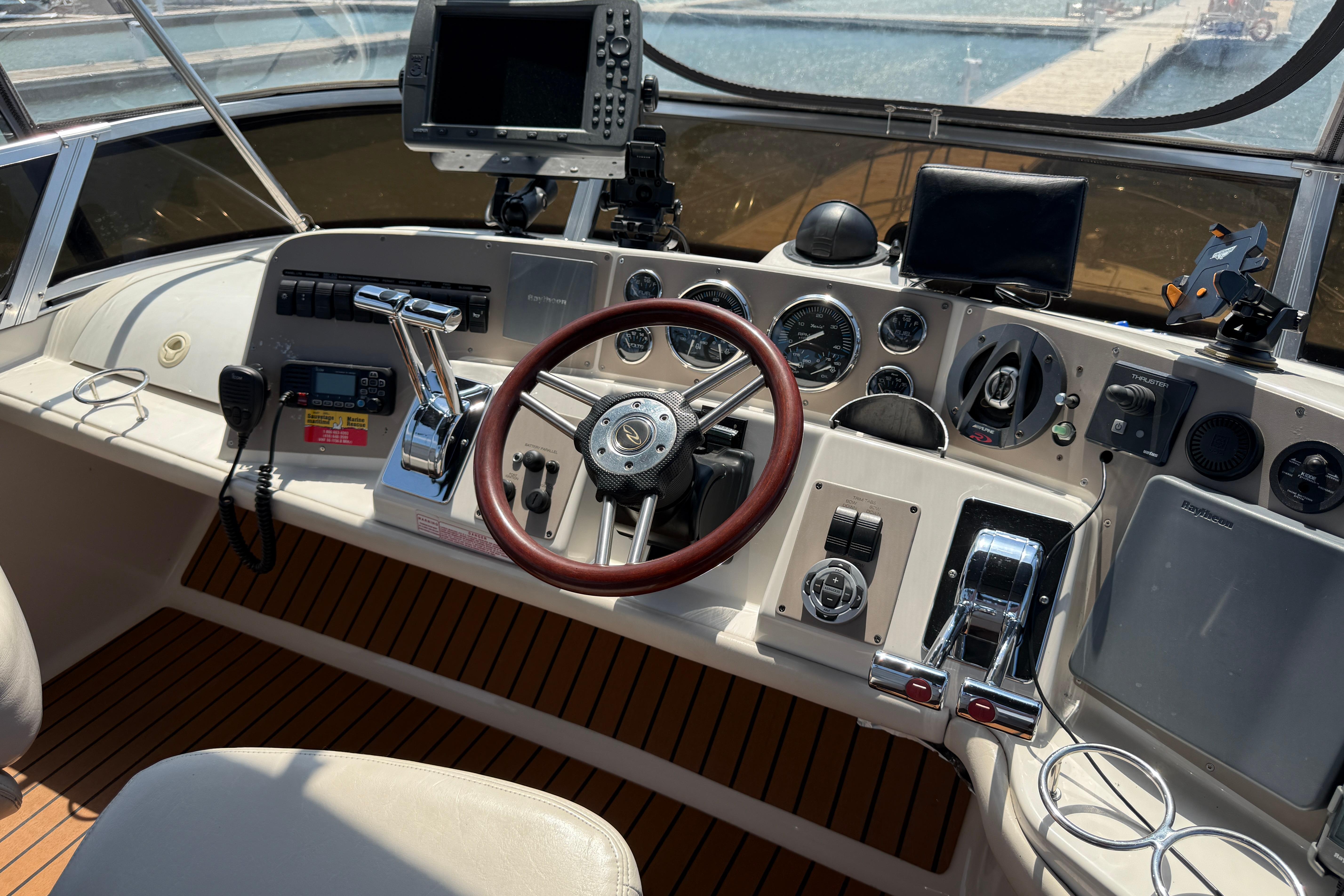 Cockpit of 2001 Regal Commodore 3780 with steering wheel and navigation equipment.