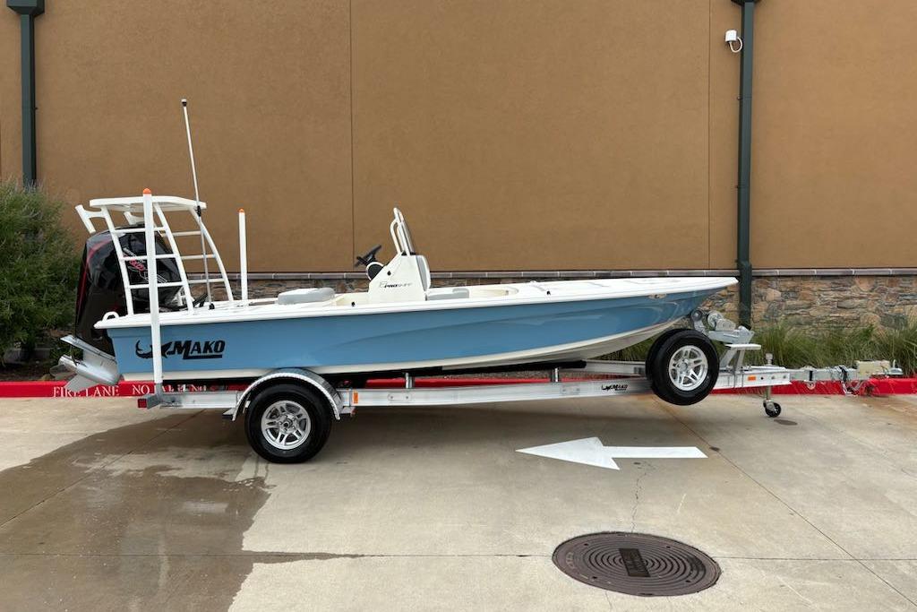 2026 Mako 18 Pro Skiff boat on trailer, parked outdoors.