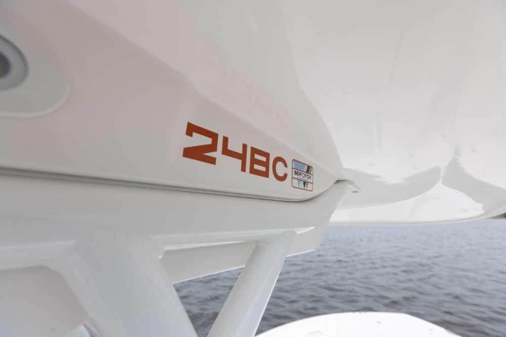 2027 Sea Fox 248 Commander boat detail with logo, viewed from water.