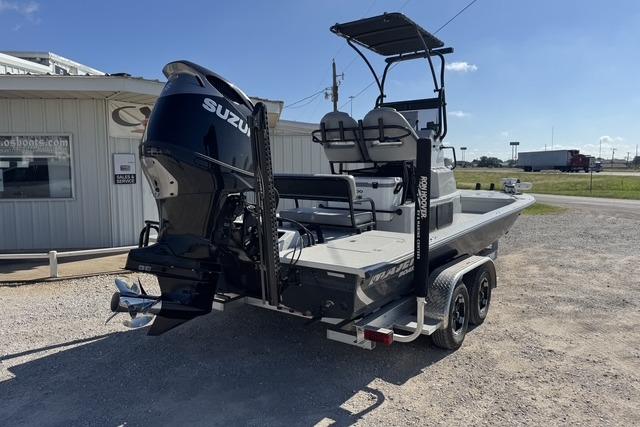 2025 Majek 24 Reaper boat with Suzuki engine on a trailer, parked outdoors.