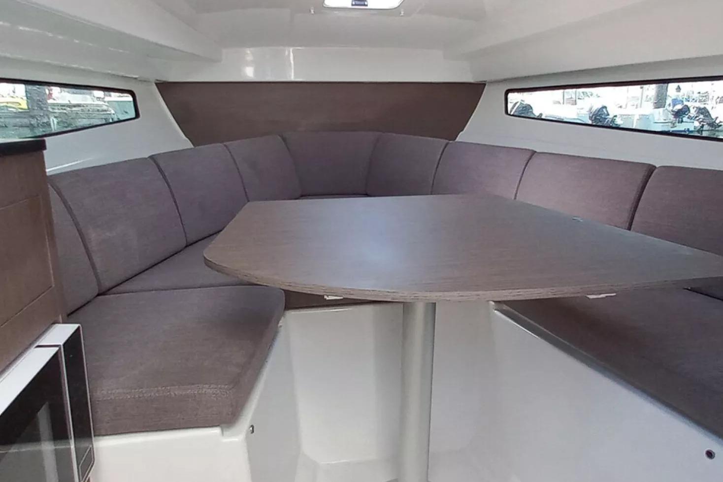 2026 Beneteau Flyer 8 SUNdeck interior with cozy seating and table.