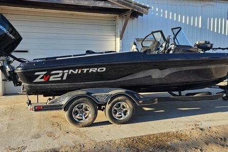 2026 Nitro ZV21 Pro boat on trailer, black exterior, parked outdoors.