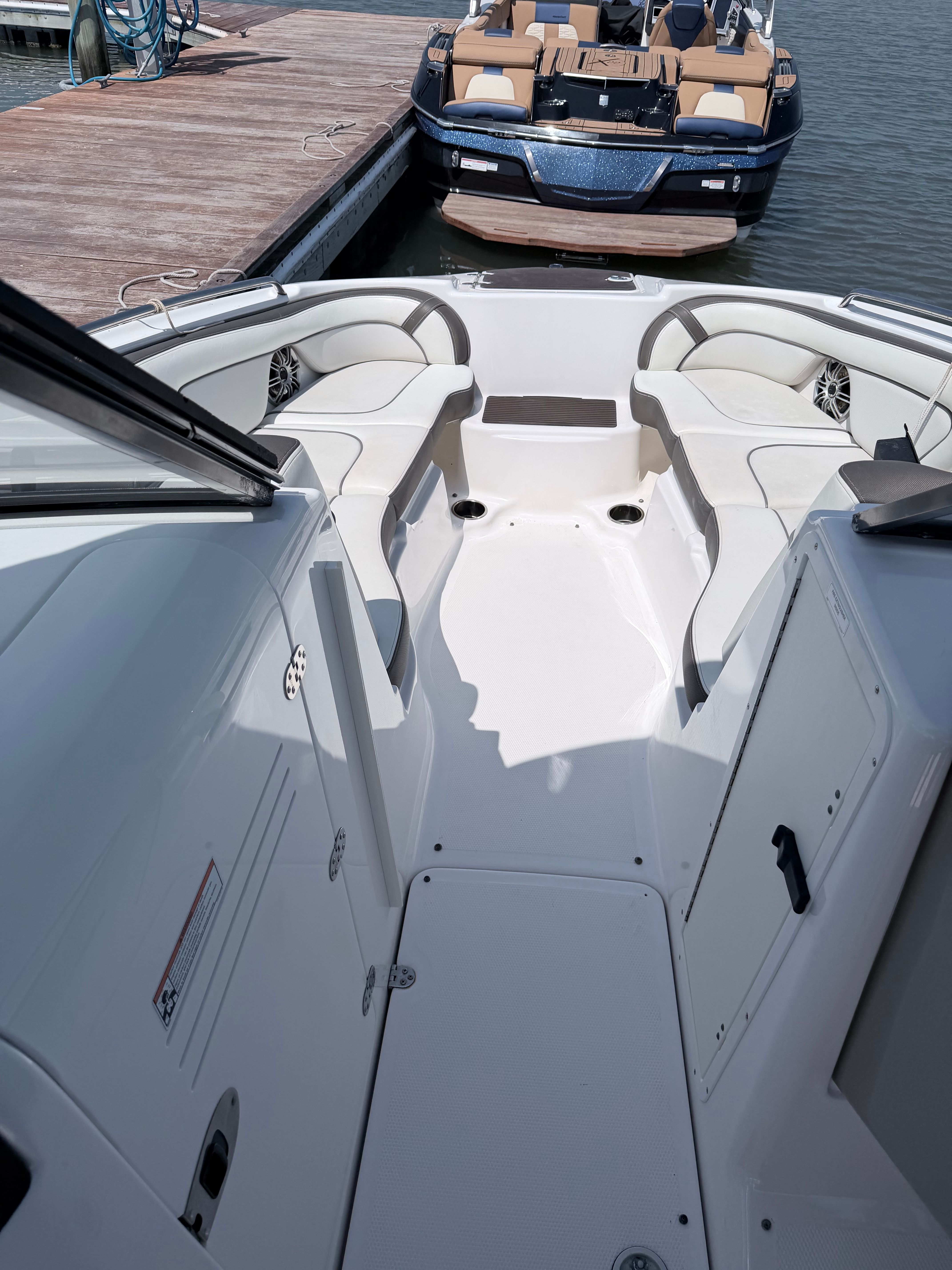 The image shows the cockpit of a 2014 Yamaha 242 Limited S boat docked at a pier.