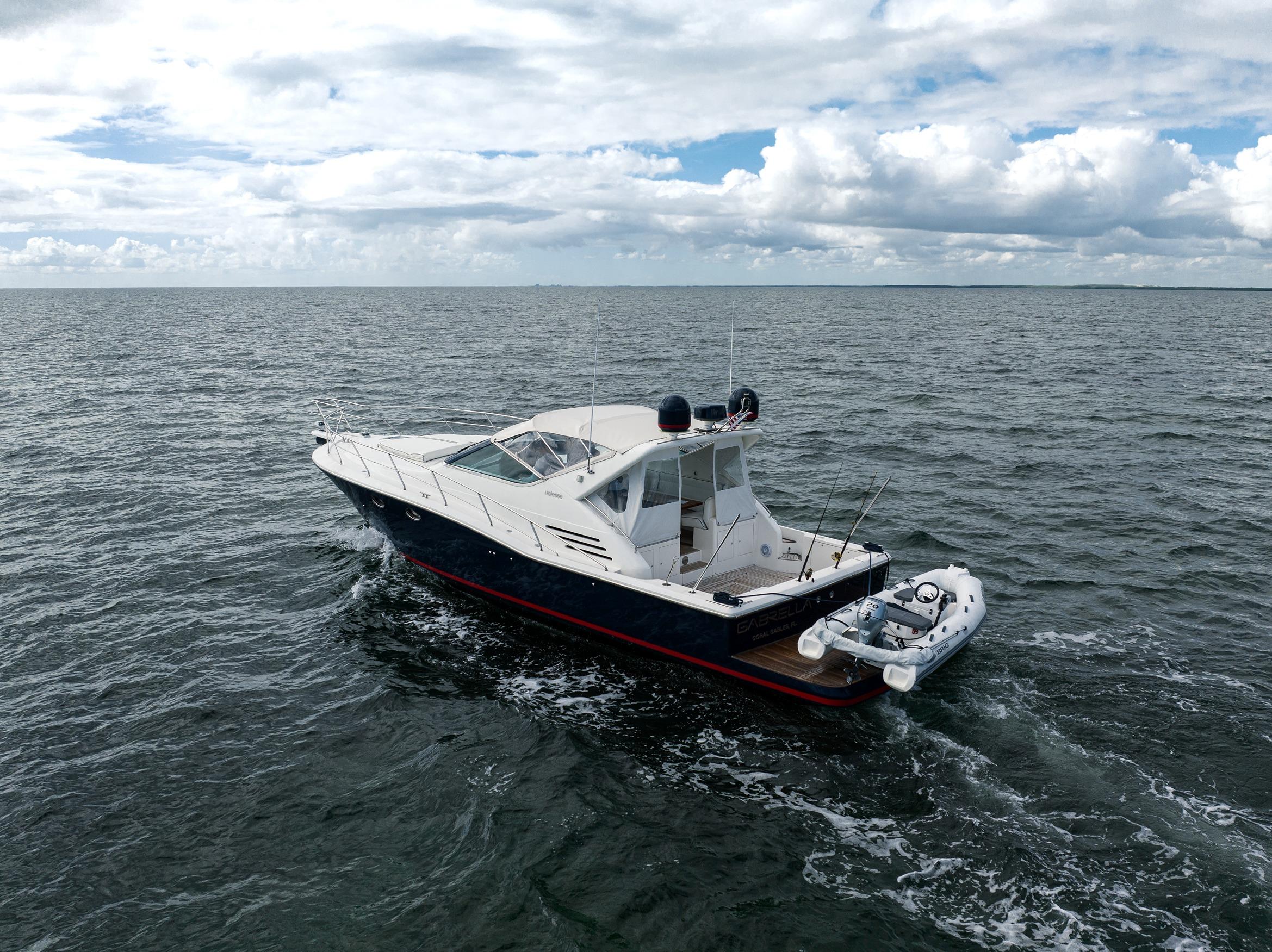 2001 Uniesse 48 Open yacht cruising on open water under cloudy skies.