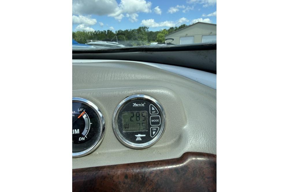 Dashboard of a 2012 Crownline 215 SS boat with digital display and trim gauge.
