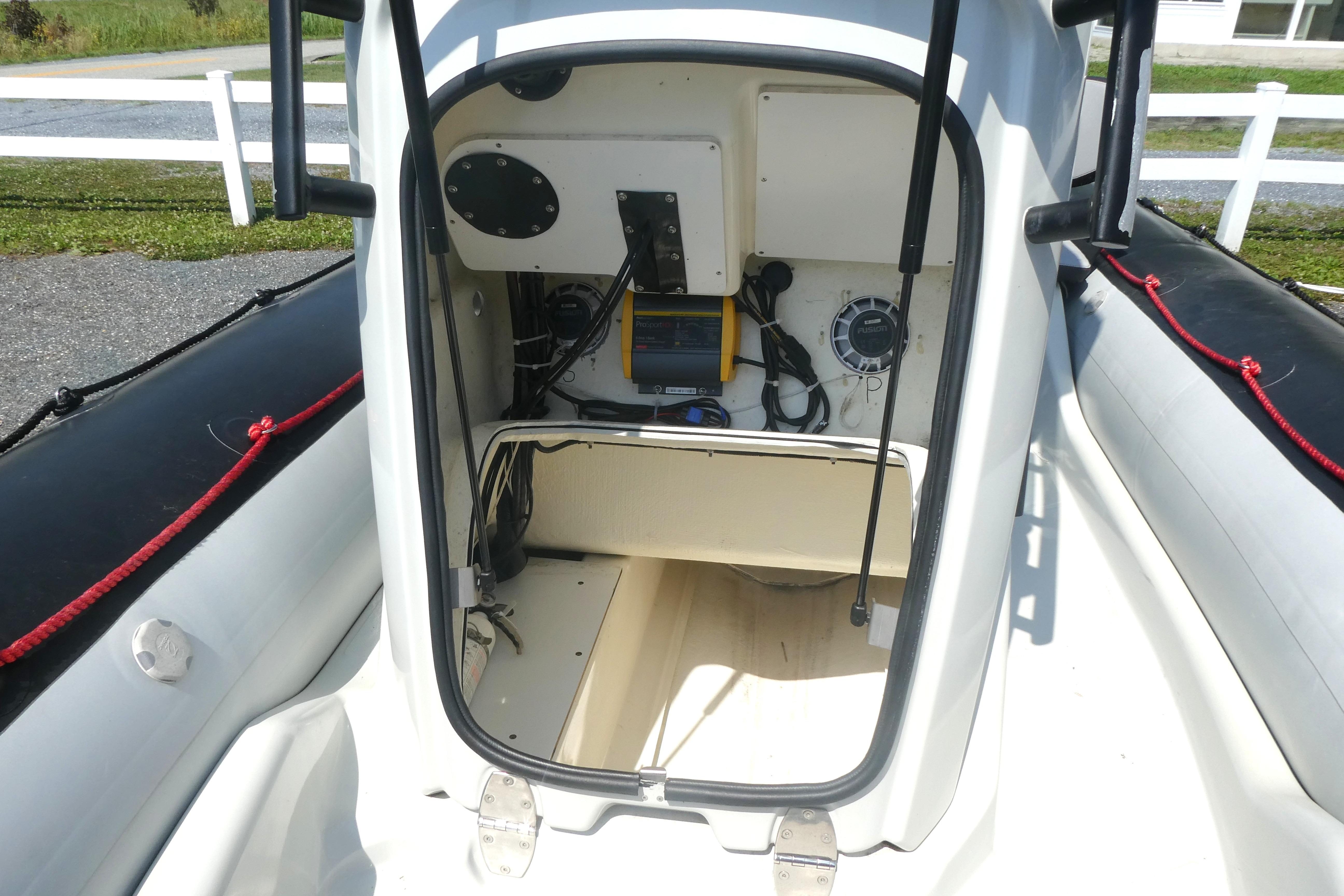 Interior view of a 2022 Zodiac Pro 5.5 boat, showcasing storage and equipment.