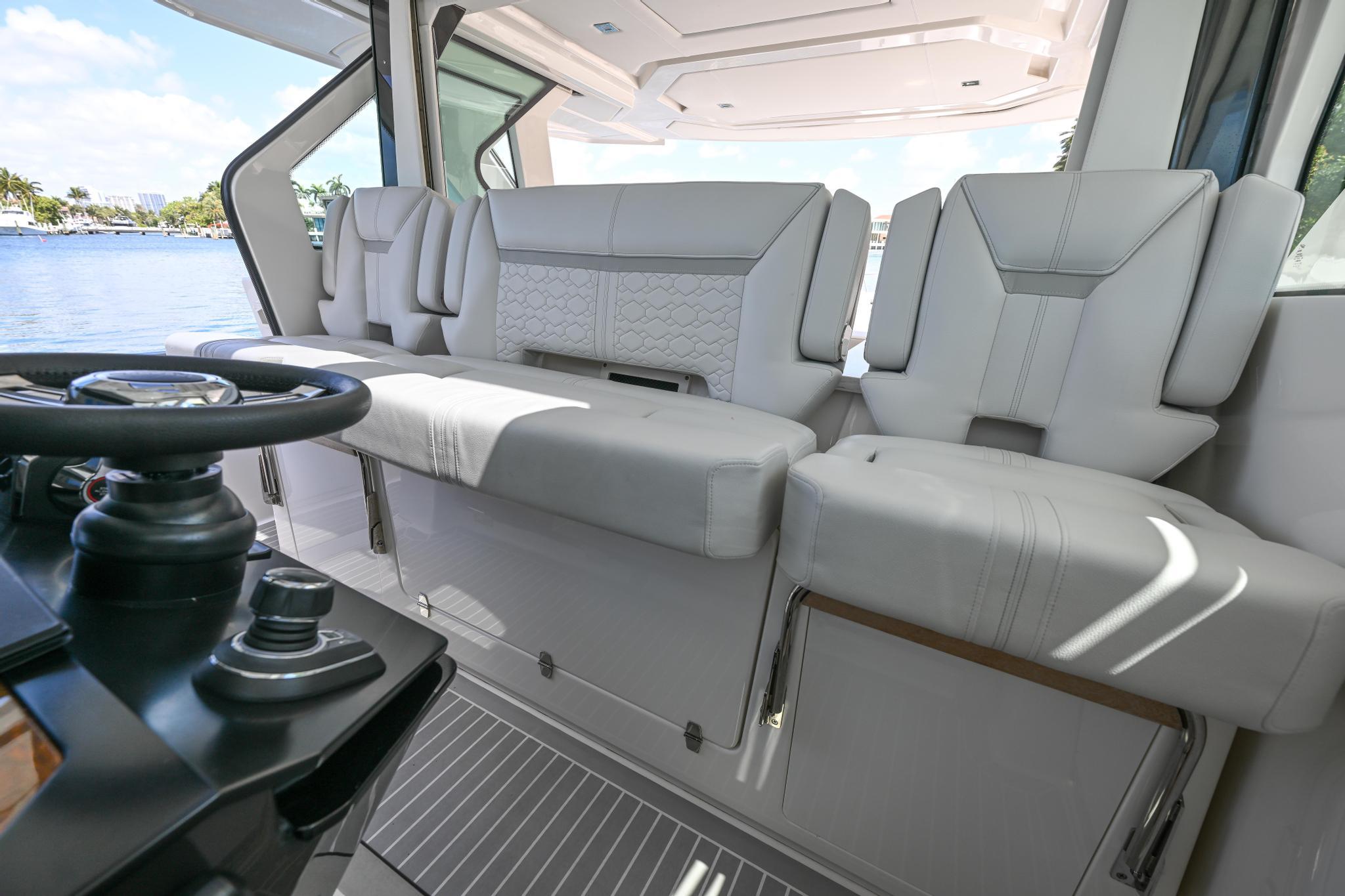 2023 Tiara Yachts 48 LS interior with luxurious seating and modern helm controls.