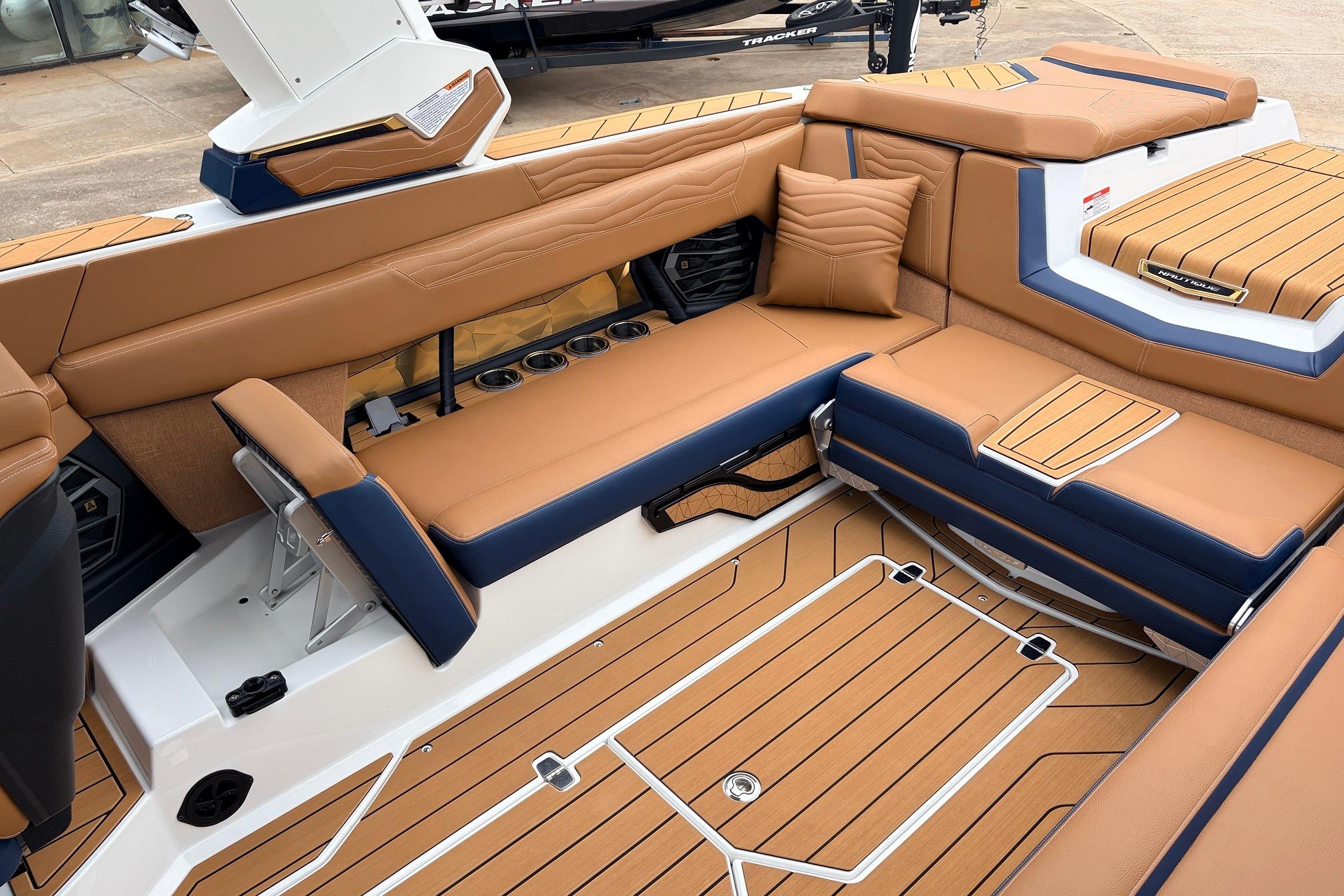 Luxurious interior of 2026 Nautique Super Air Nautique G25 boat with tan and navy seating.