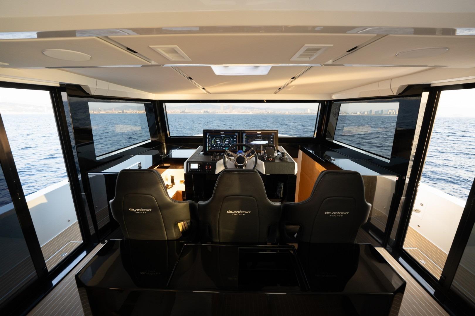 Interior view of 2026 De Antonio Yachts D60, featuring modern helm and panoramic windows.