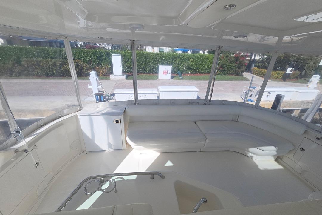 Spacious interior of 2003 Sea Ray 390 Motor Yacht with white seating and large windows.