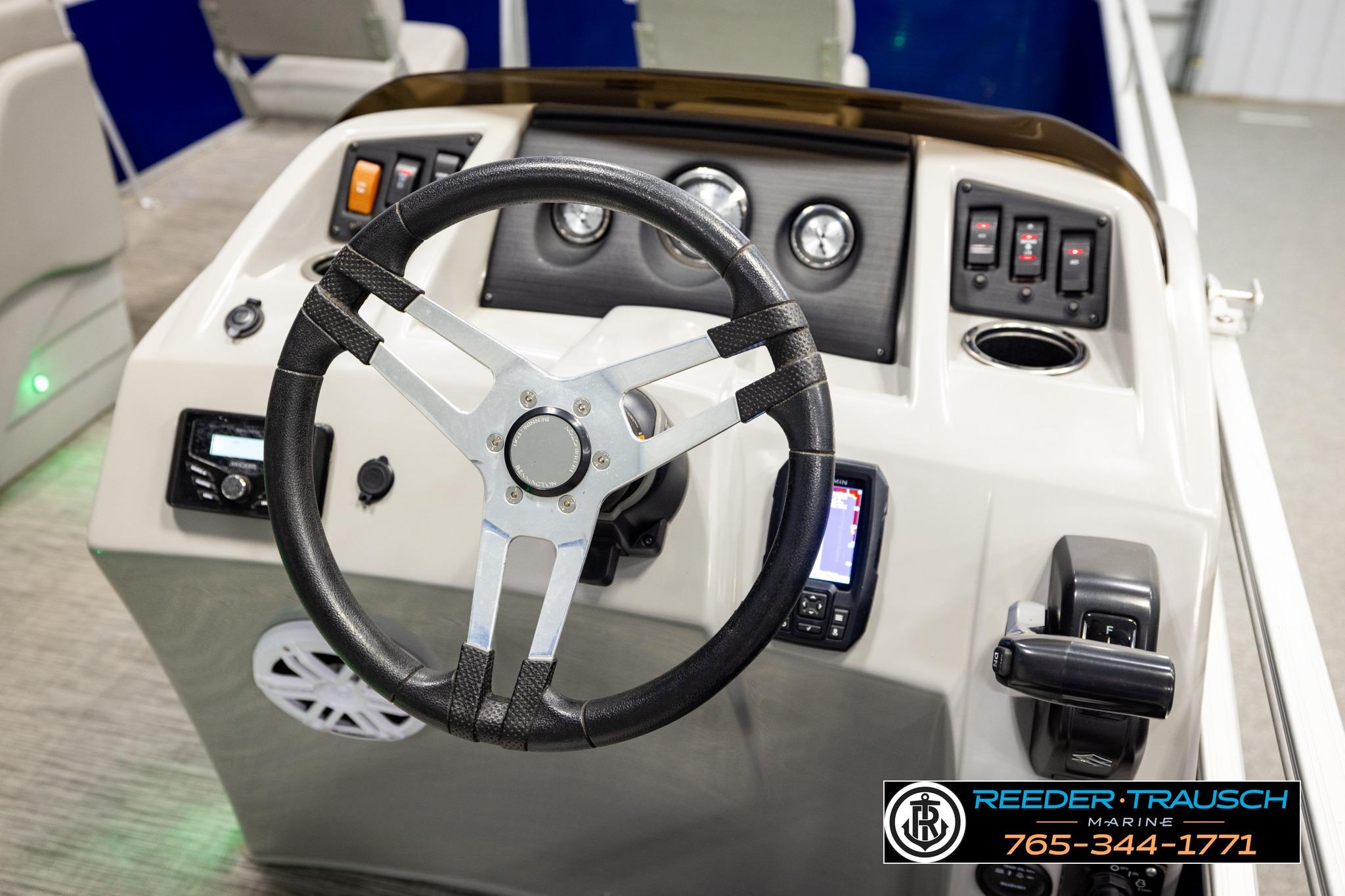 Steering console of a 2021 Bennington 20 SV pontoon boat with controls and gauges.