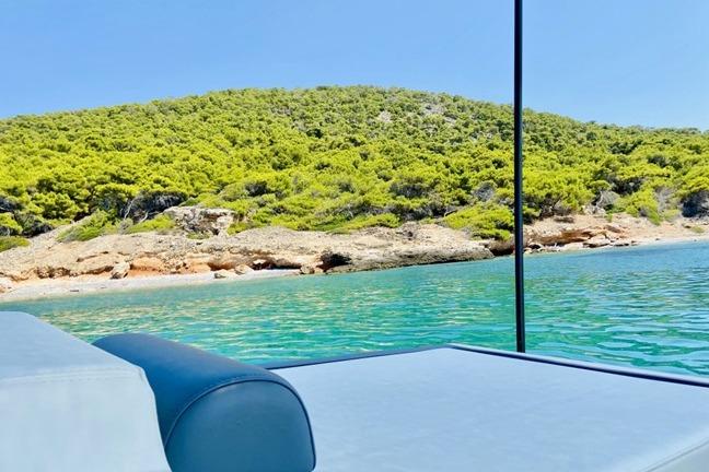2020 Technohull Explorer boat with scenic coastal view and lush greenery.