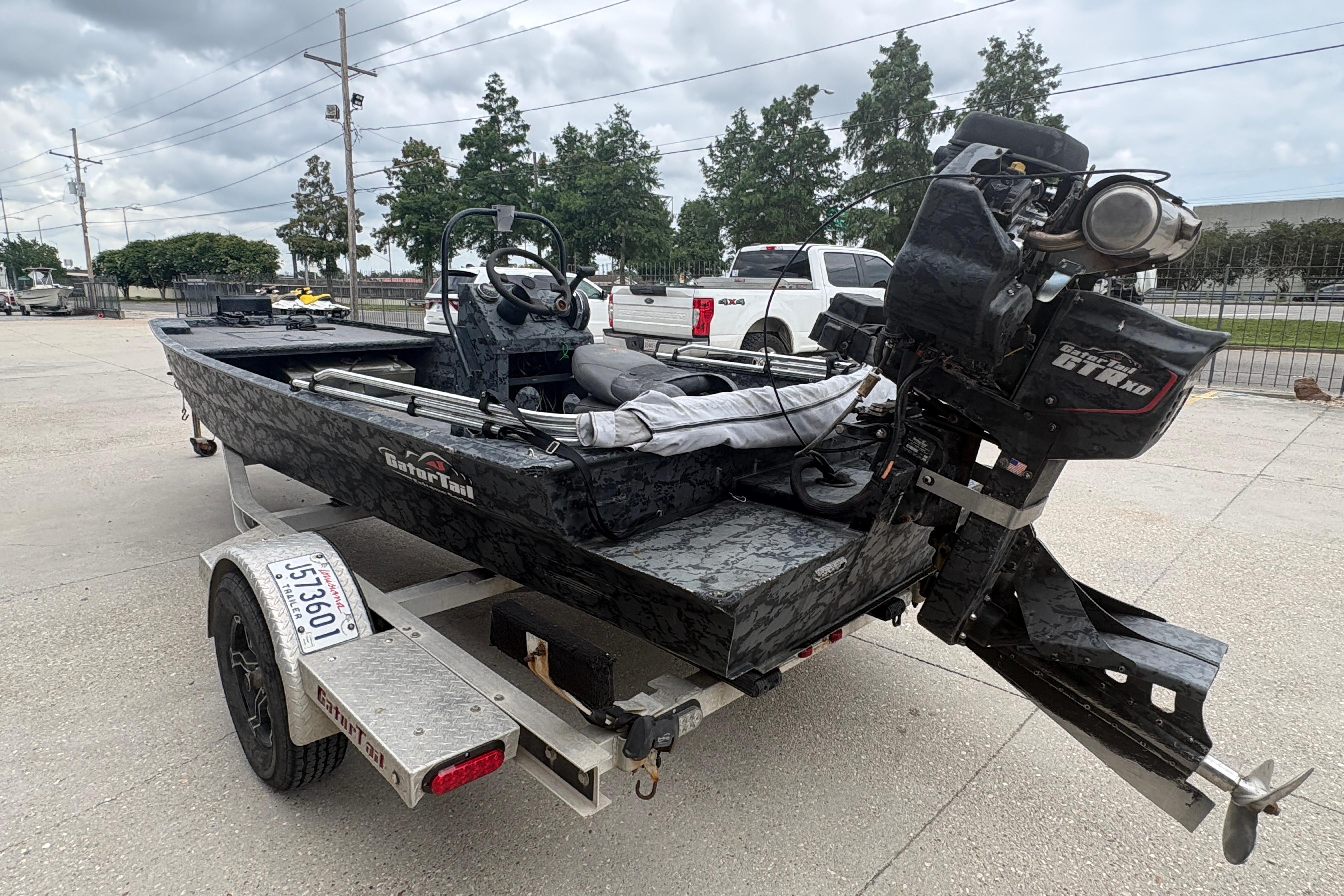 2020 Gator Tail Extreme boat on trailer, parked outdoors under cloudy sky.