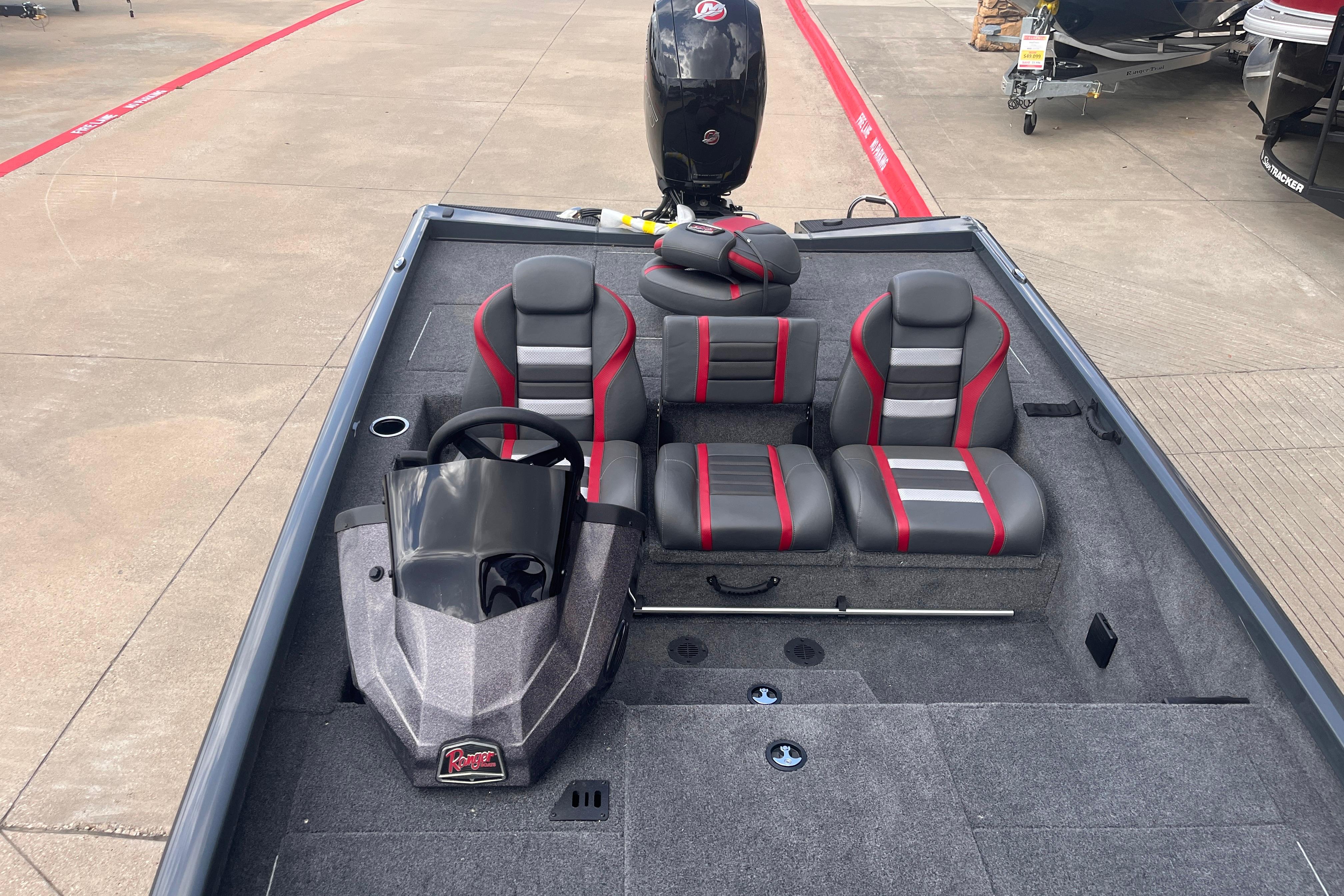 2026 Ranger RT198P boat interior with gray and red seating, steering console, and motor.