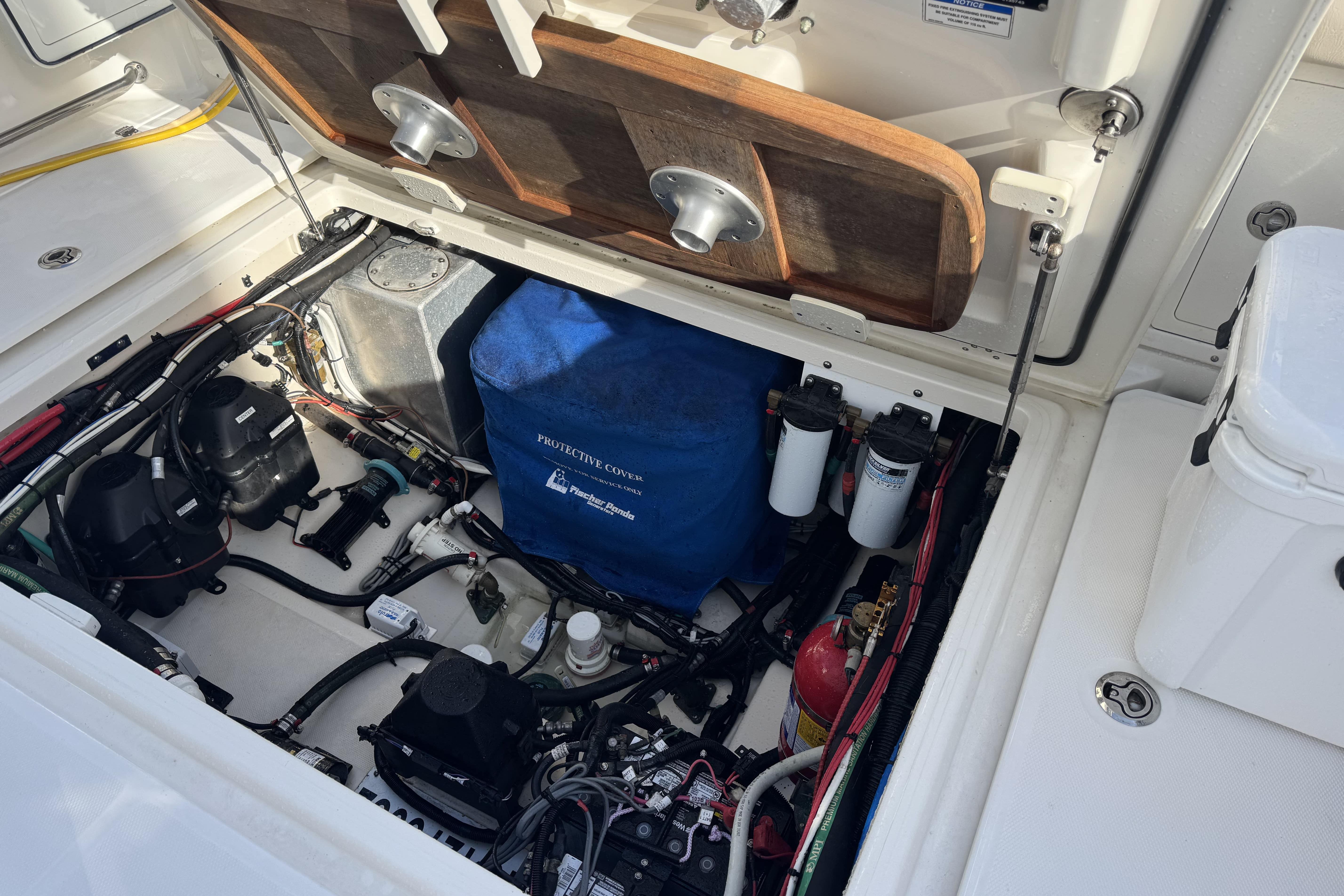 2017 Boston Whaler 370 Outrage engine compartment with protective cover and equipment.