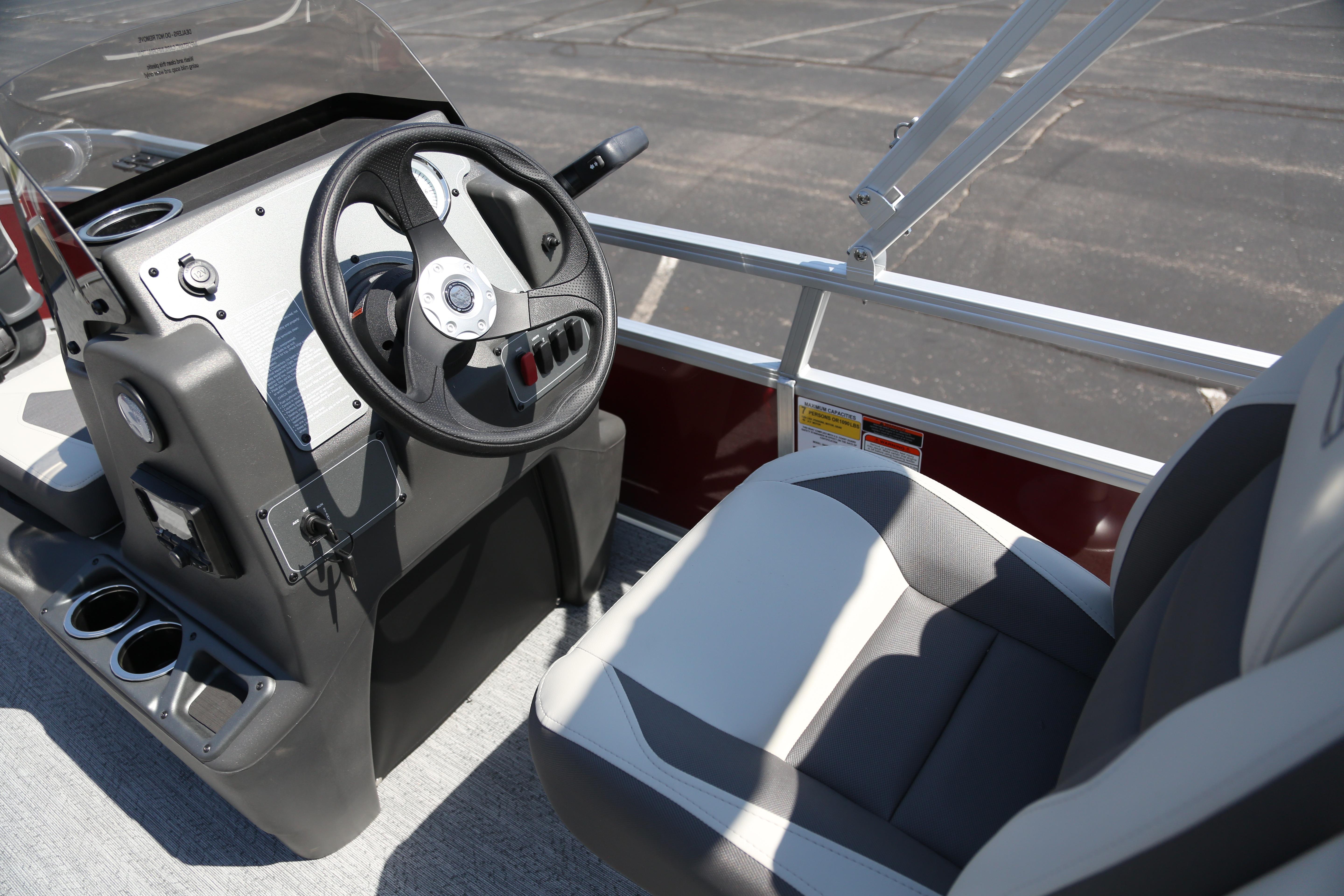 2026 Sun Tracker Bass Buggy 16 XL Select boat interior with steering wheel and seating.