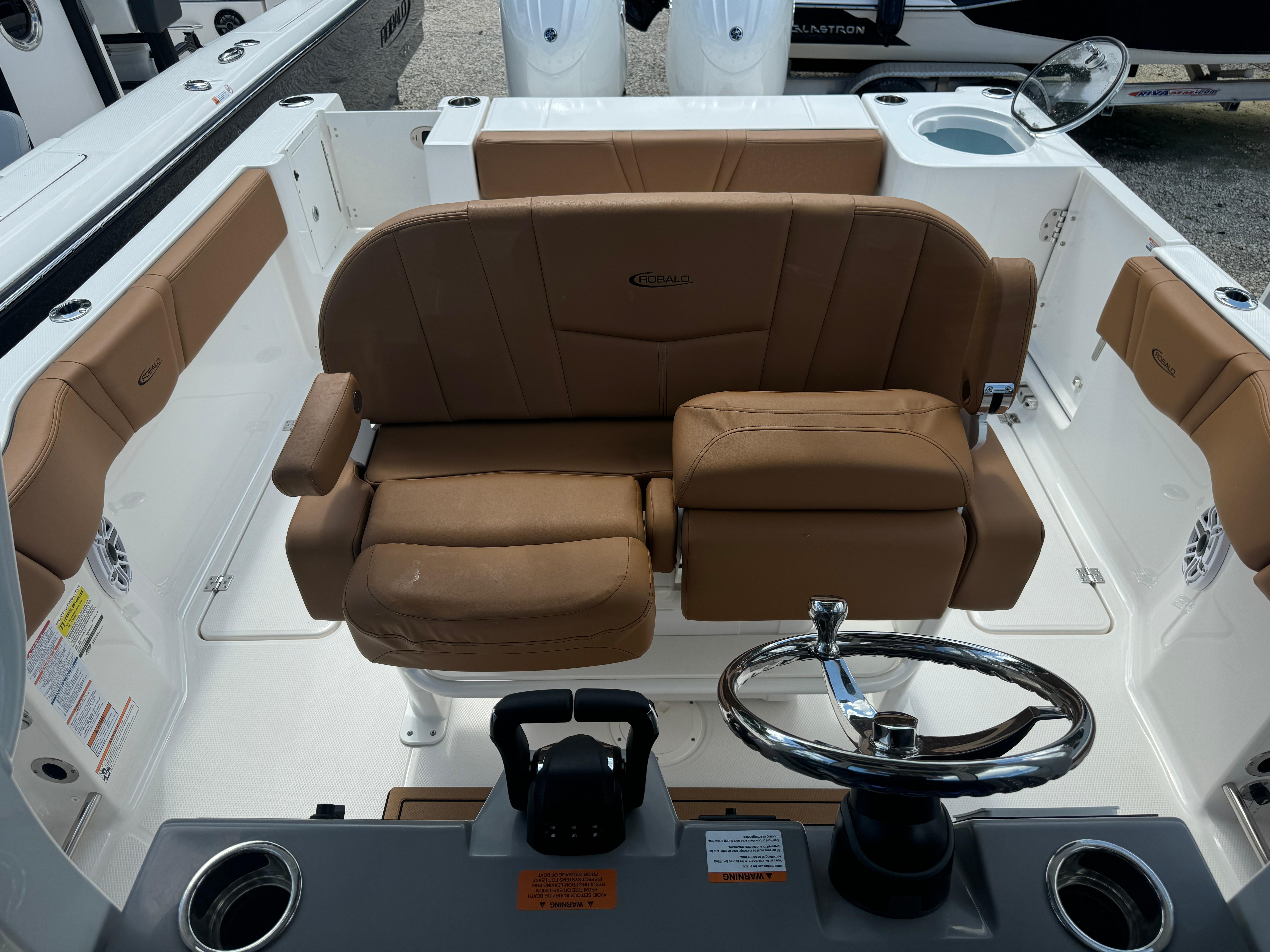 2025 Robalo R250 Center Console boat interior with brown seating and steering wheel.