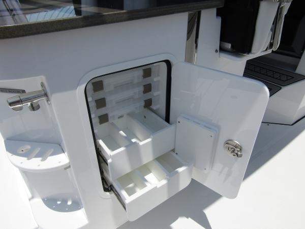 2024 Wellcraft 352 Fisherman boat storage compartment with open drawers.