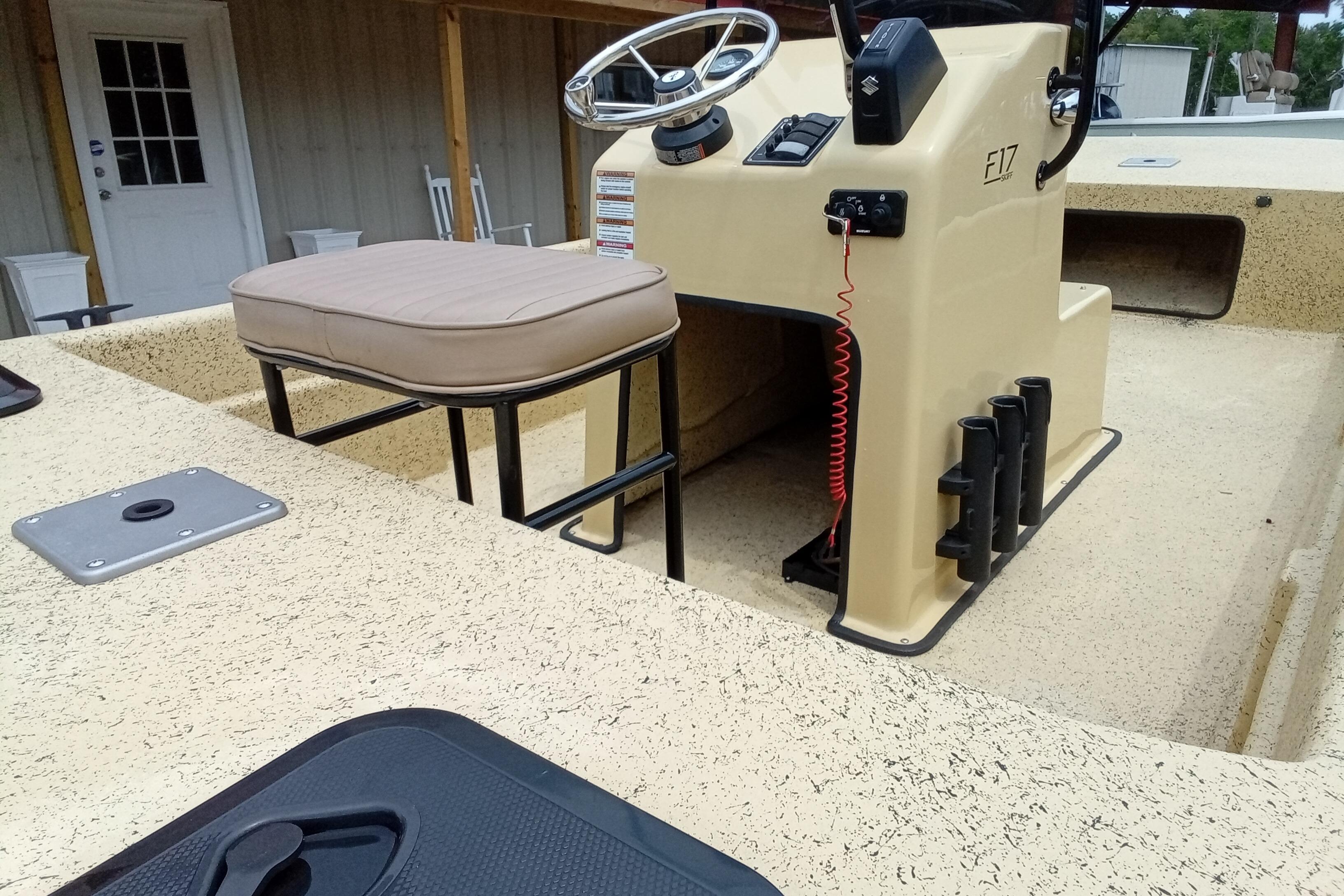 Fibercraft F17 boat interior, 2025 model, featuring steering console and seating.