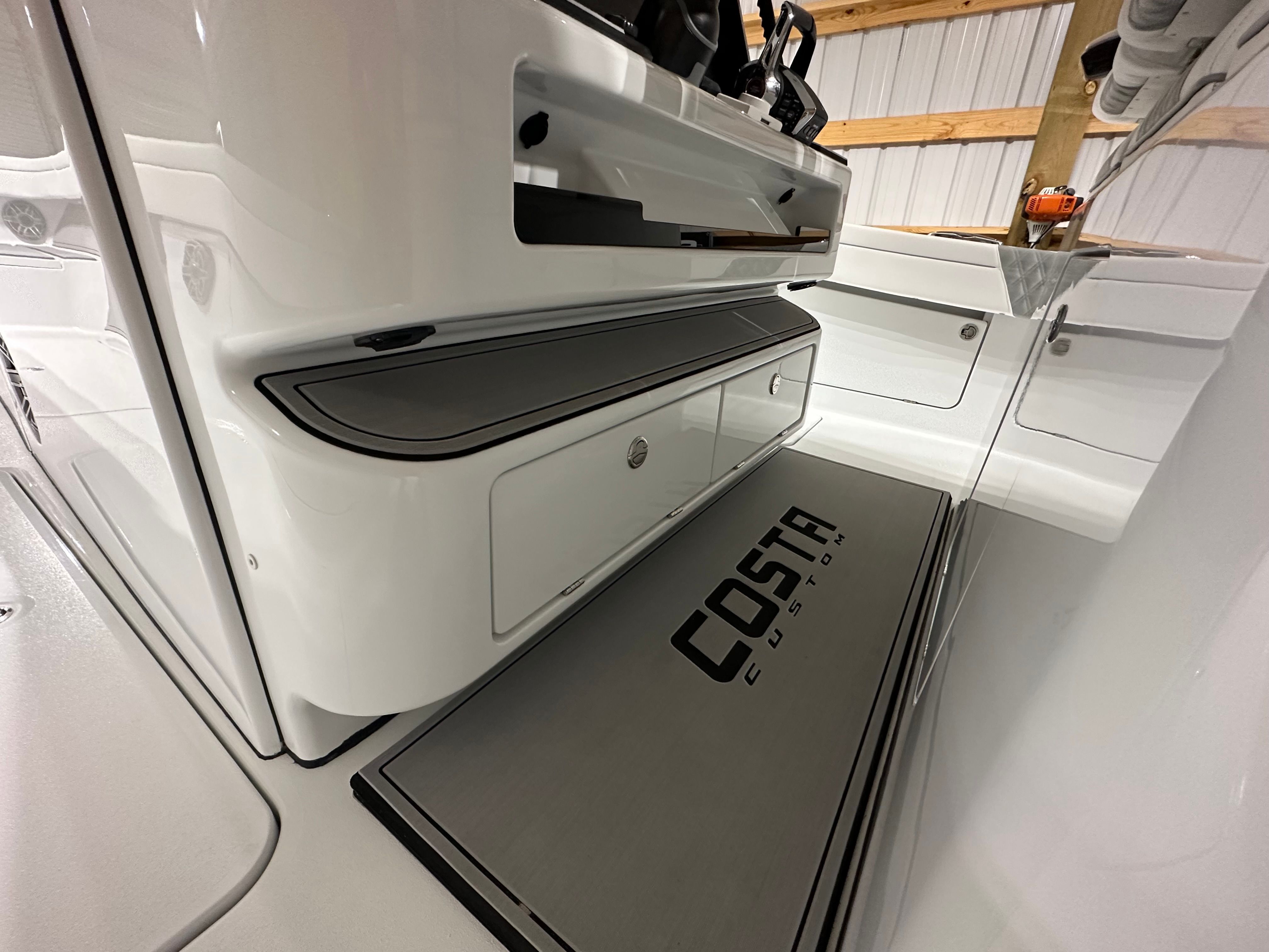 Interior view of a Costa Custom Boats 34SV with gray accents and storage space.