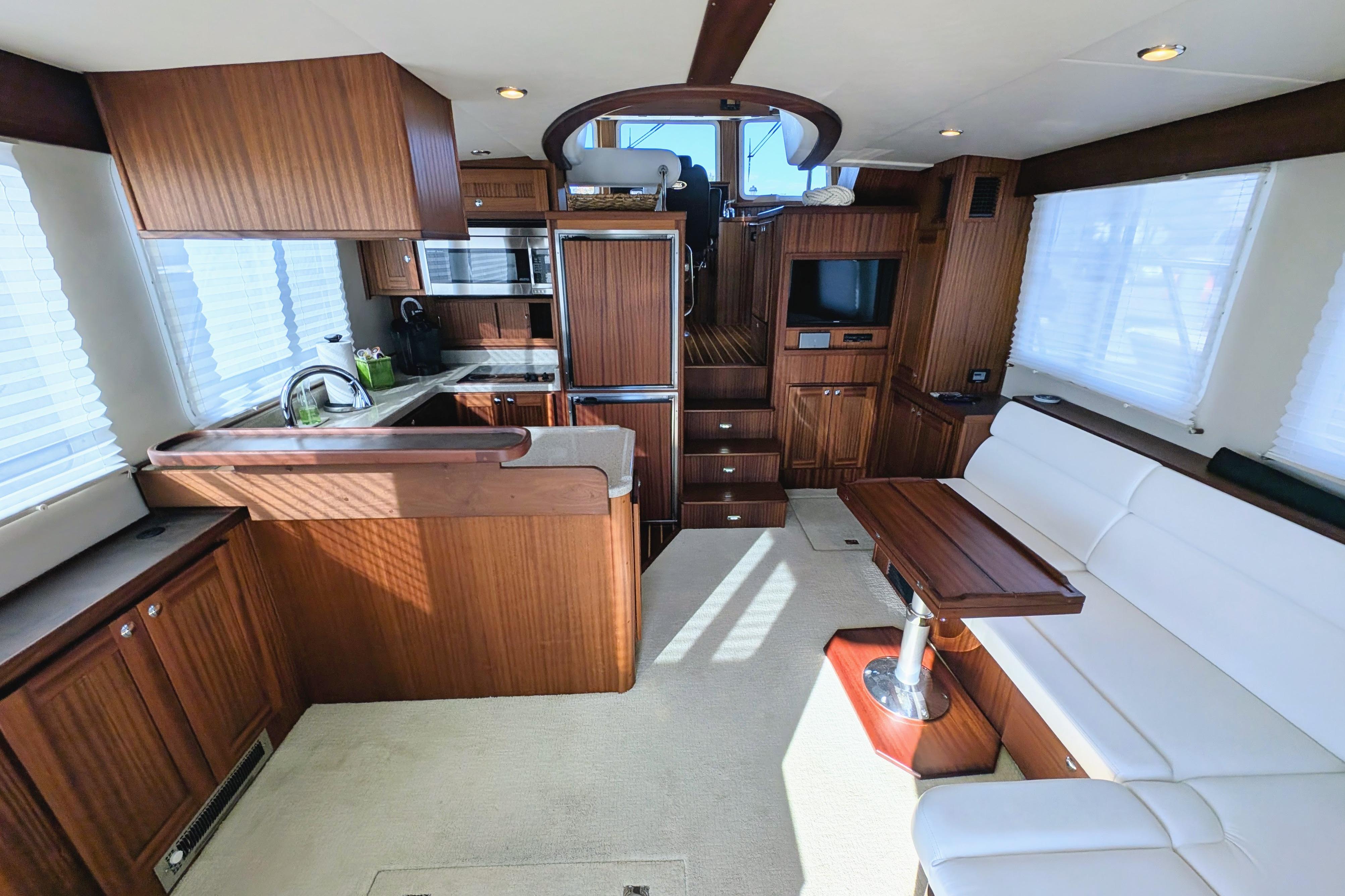 Luxurious interior of 2015 American Tug 435 with modern kitchen and comfortable seating.