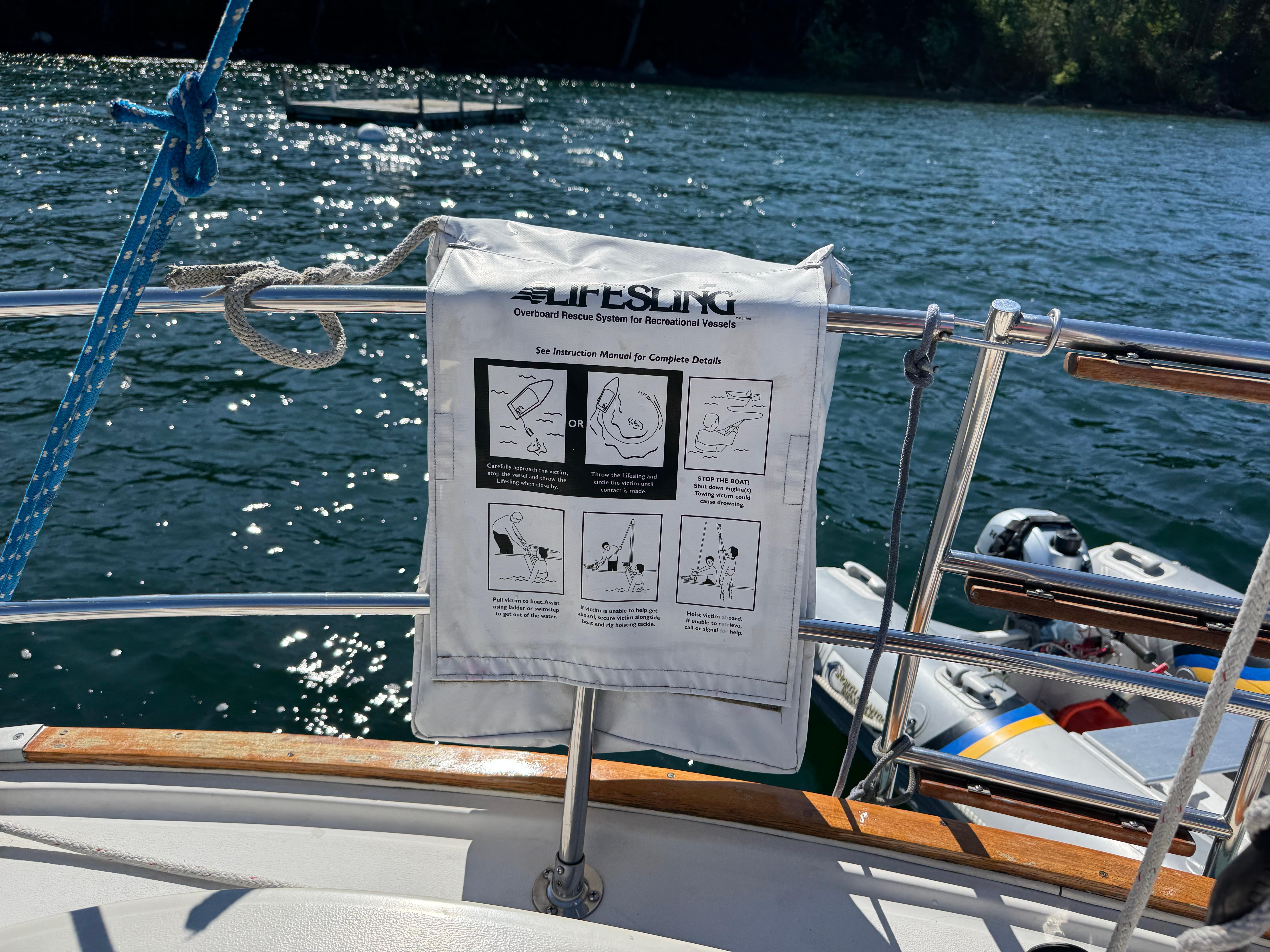 Lifesling rescue system on 1989 Nonsuch 30 Ultra sailboat, with water and dinghy in background.