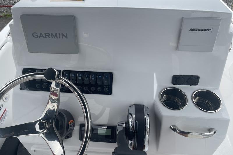 2025 Stingray 173CC boat dashboard with Garmin and Mercury controls, steering wheel, and cup holders.
