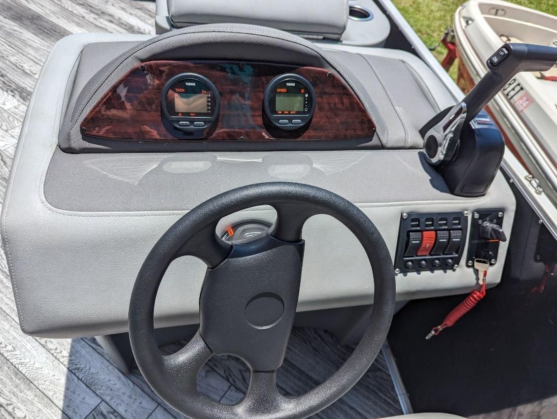 2022 Crest Pontoon boat dashboard with tachometers and throttle lever.