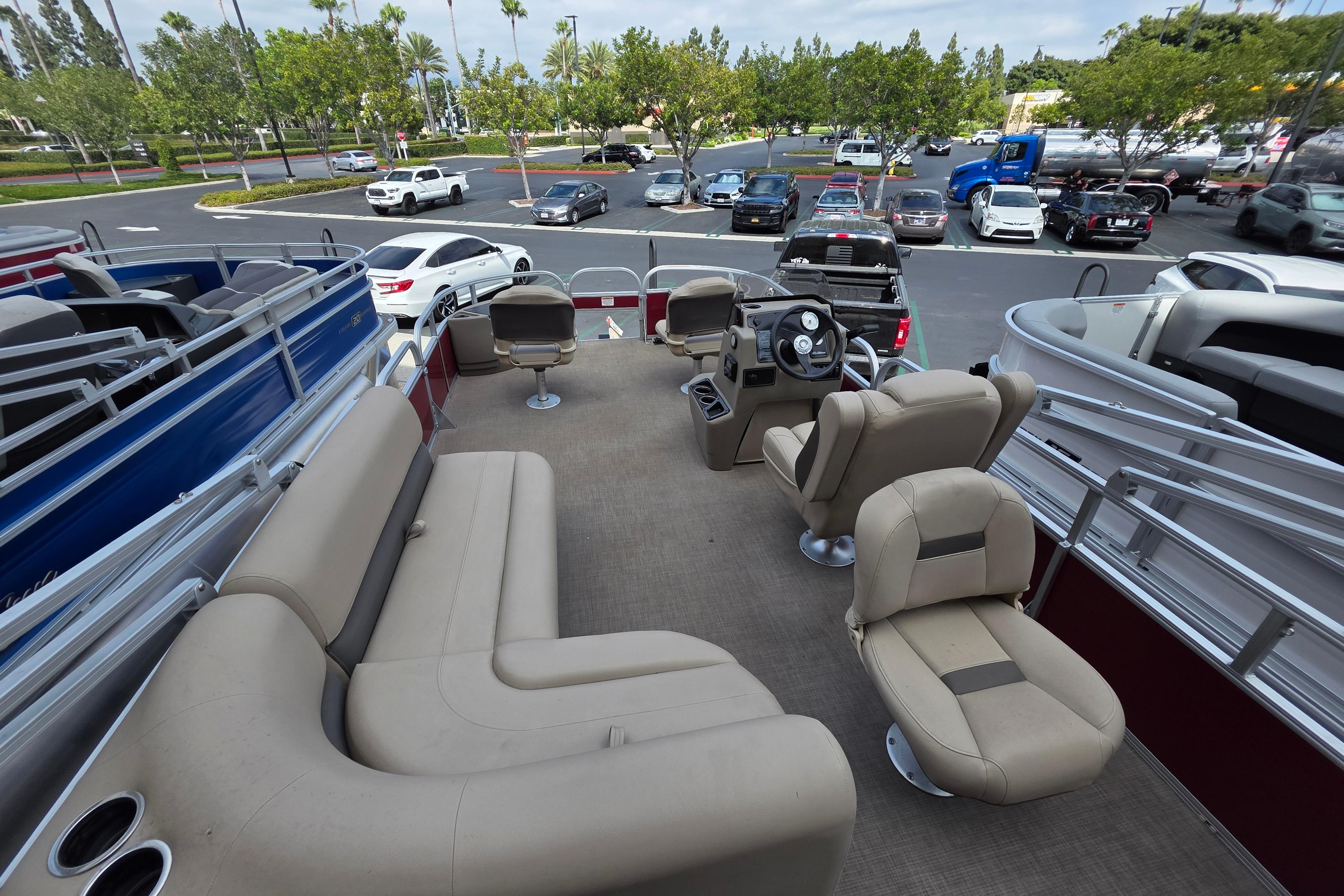 2025 Sun Tracker Bass Buggy 18 DLX pontoon boat interior with seating and steering console.