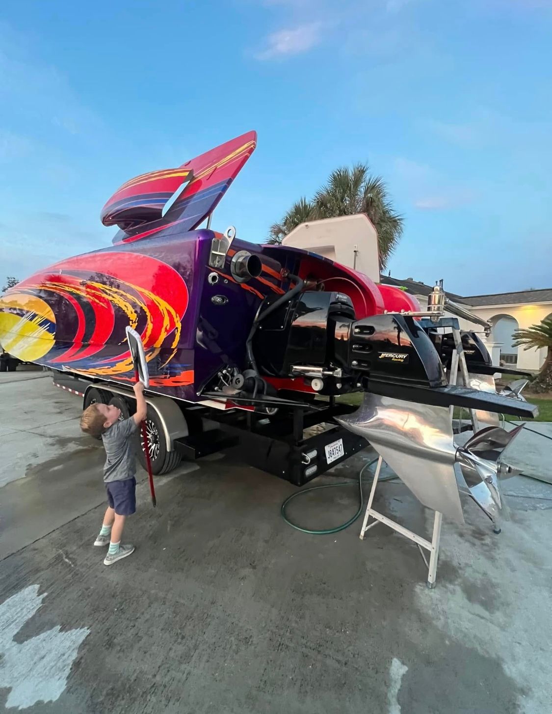 Child observes 2003 Skater 40 S.S. boat with colorful design.