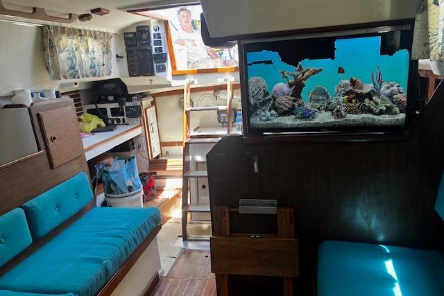 Interior of a 1979 Pearson 365 Ketch sailboat with vibrant seating and a built-in aquarium.
