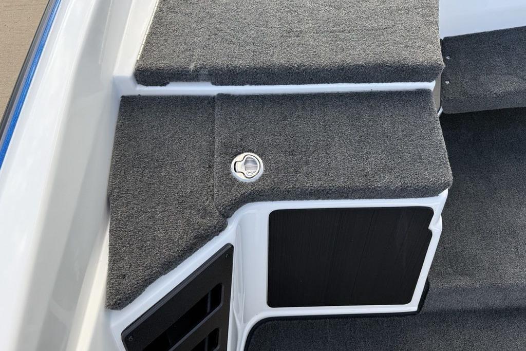 2026 Skeeter ZXR19 SE boat interior with carpeted steps and storage compartment.