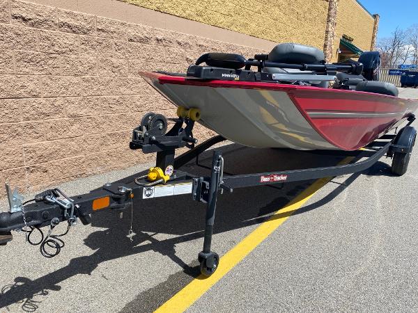 2025 Tracker Bass Tracker Classic XL boat on trailer, parked beside a brick wall.