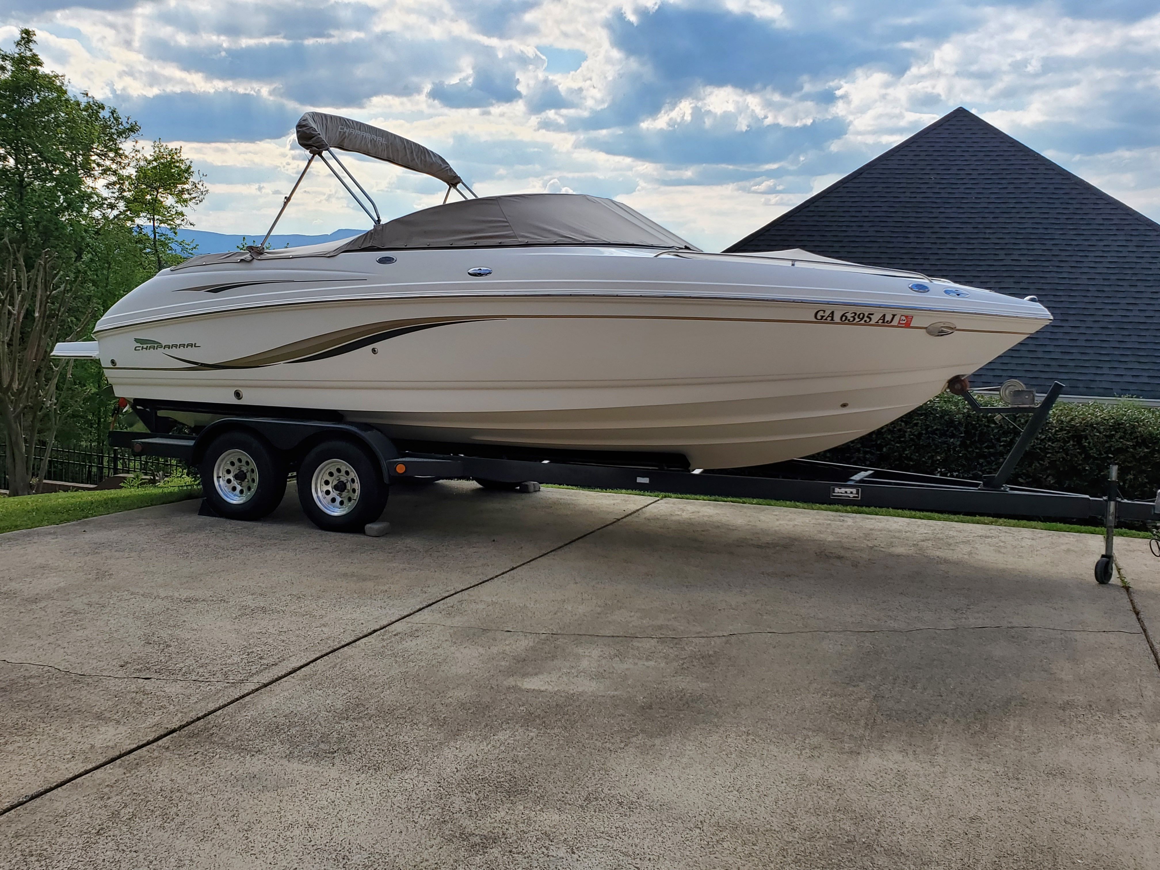 2003 Chaparral 230 SSi boat on trailer in driveway.