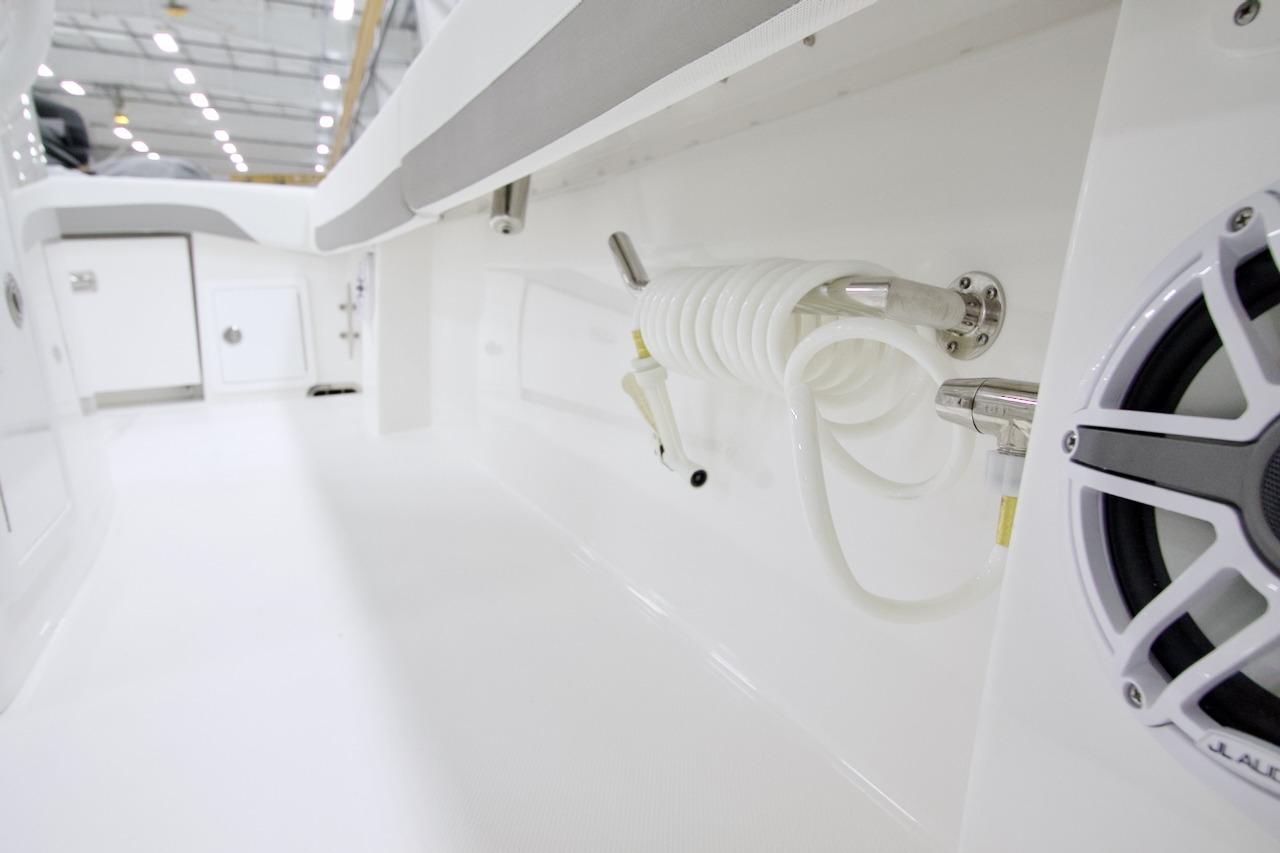 2026 Regulator 31 boat interior with coiled hose and speaker in a sleek, white design.