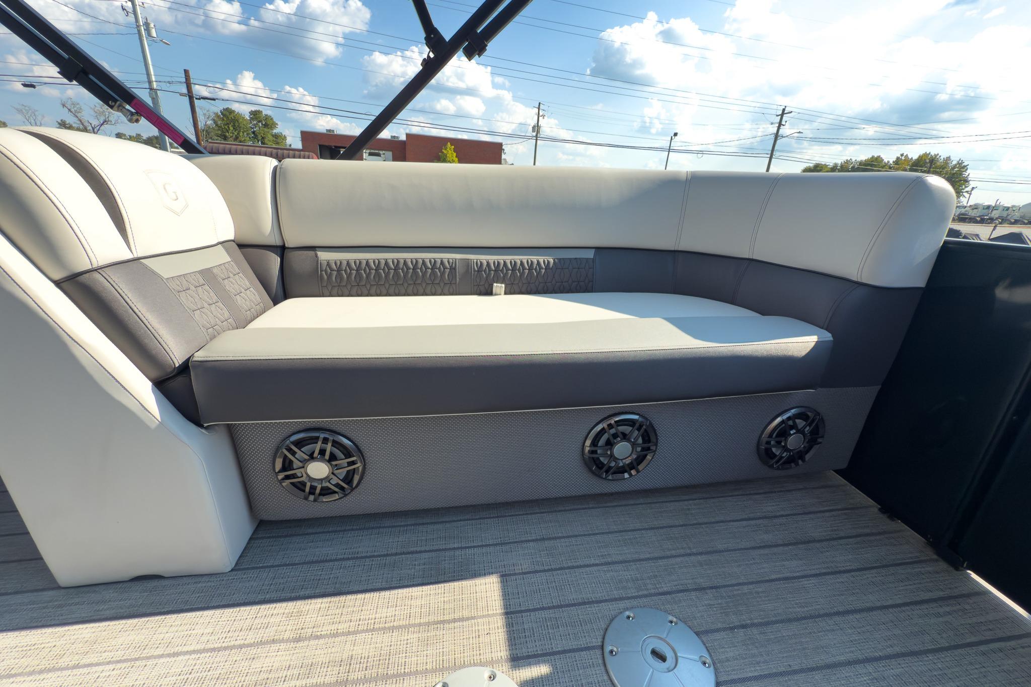 Luxurious seating on 2024 Godfrey Sweetwater 22' pontoon boat, featuring stylish design and speakers.