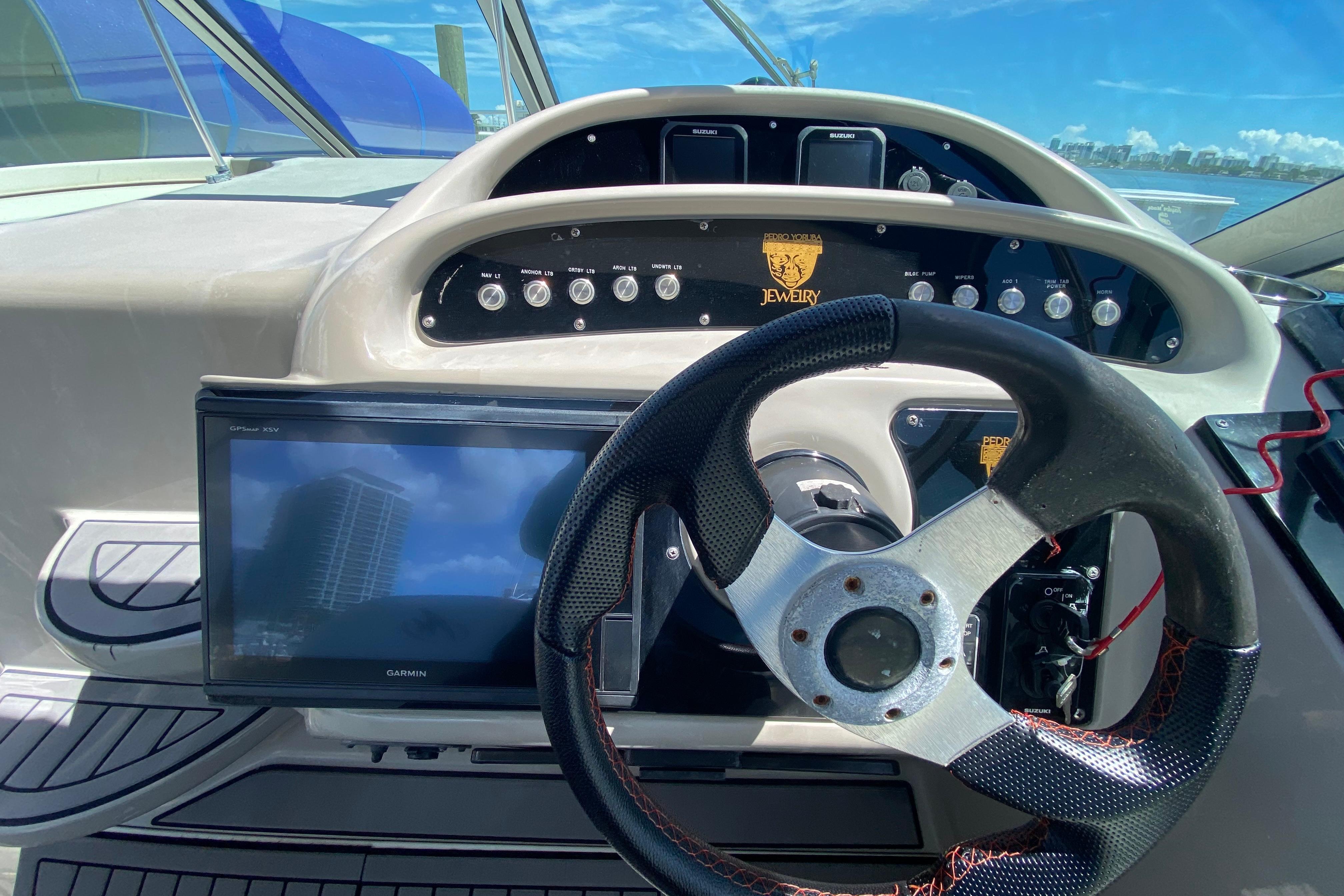 Steering console of a 2005 Monterey 302 Cruiser with navigation display and controls.
